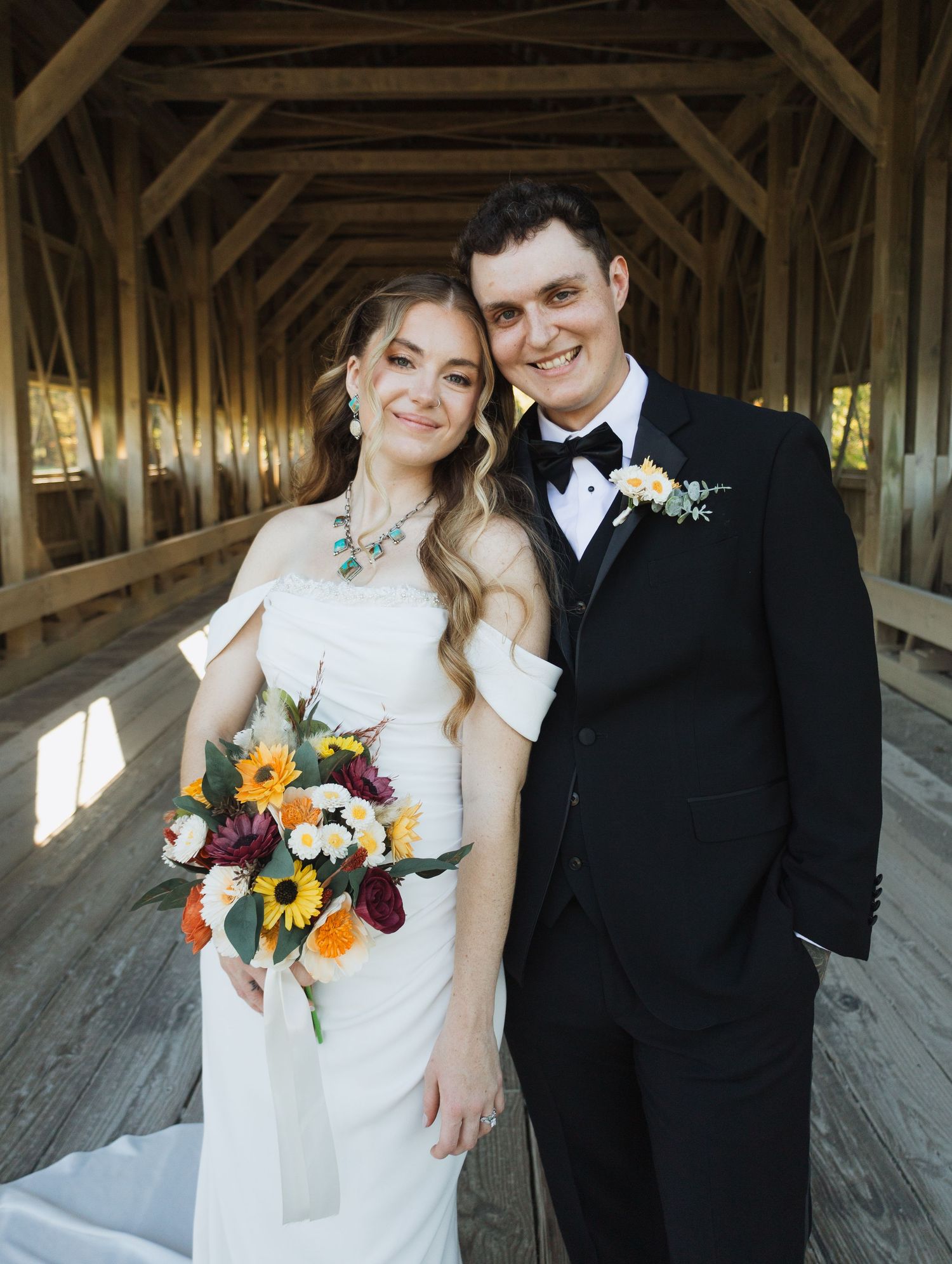 Romantic wedding portraits taken inside a rustic wooden barn.