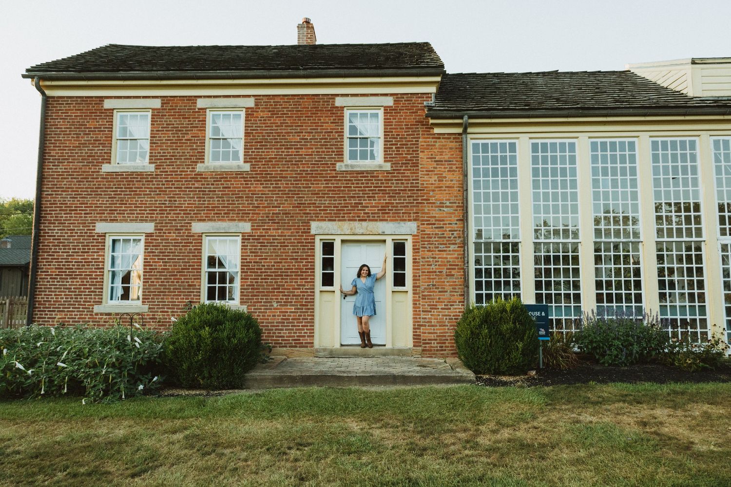 Historic red brick colonial buildings with white trim and windows form a connected residential complex.