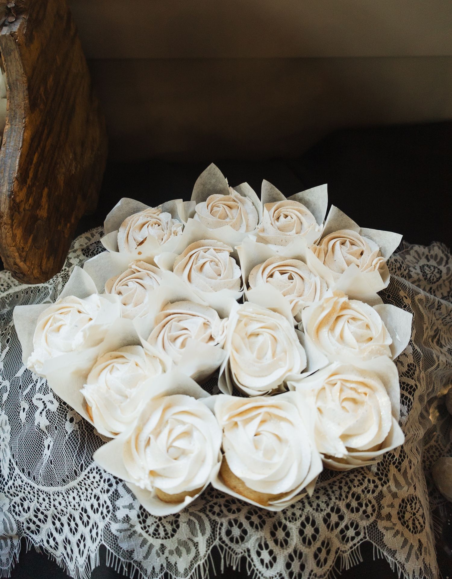 Delicate white fabric roses arranged with lace detailing in vintage style.