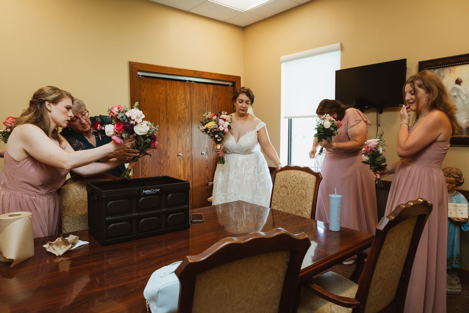 Wedding party getting ready in a sunlit room with warm wood details.