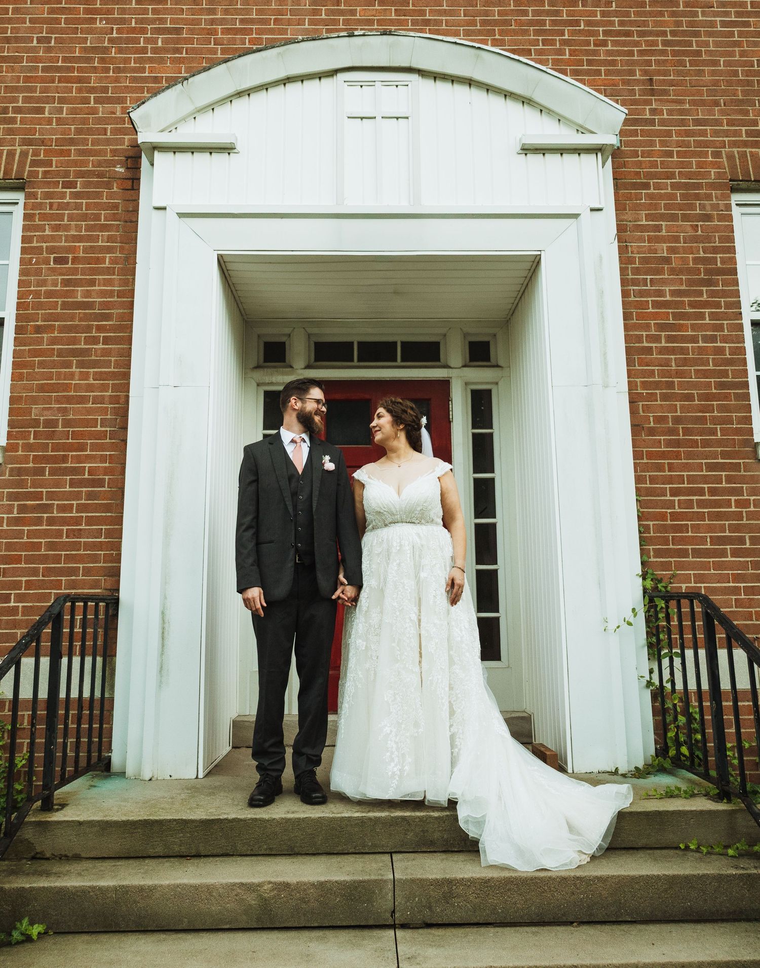 Four sequential wedding photos showing a couple posing in white arched doorways of a brick church building.
