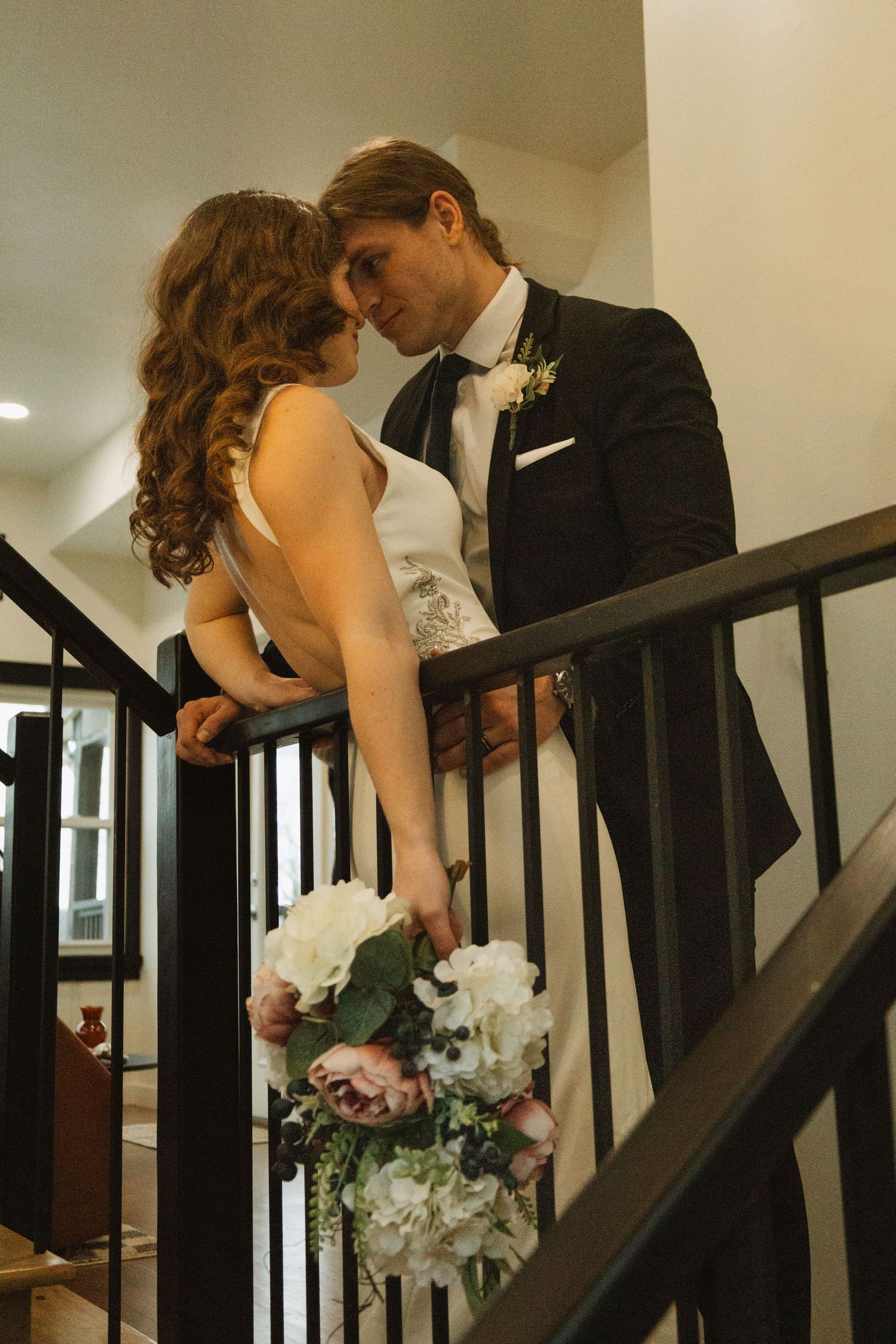 Romantic moment captured on an elegant staircase.