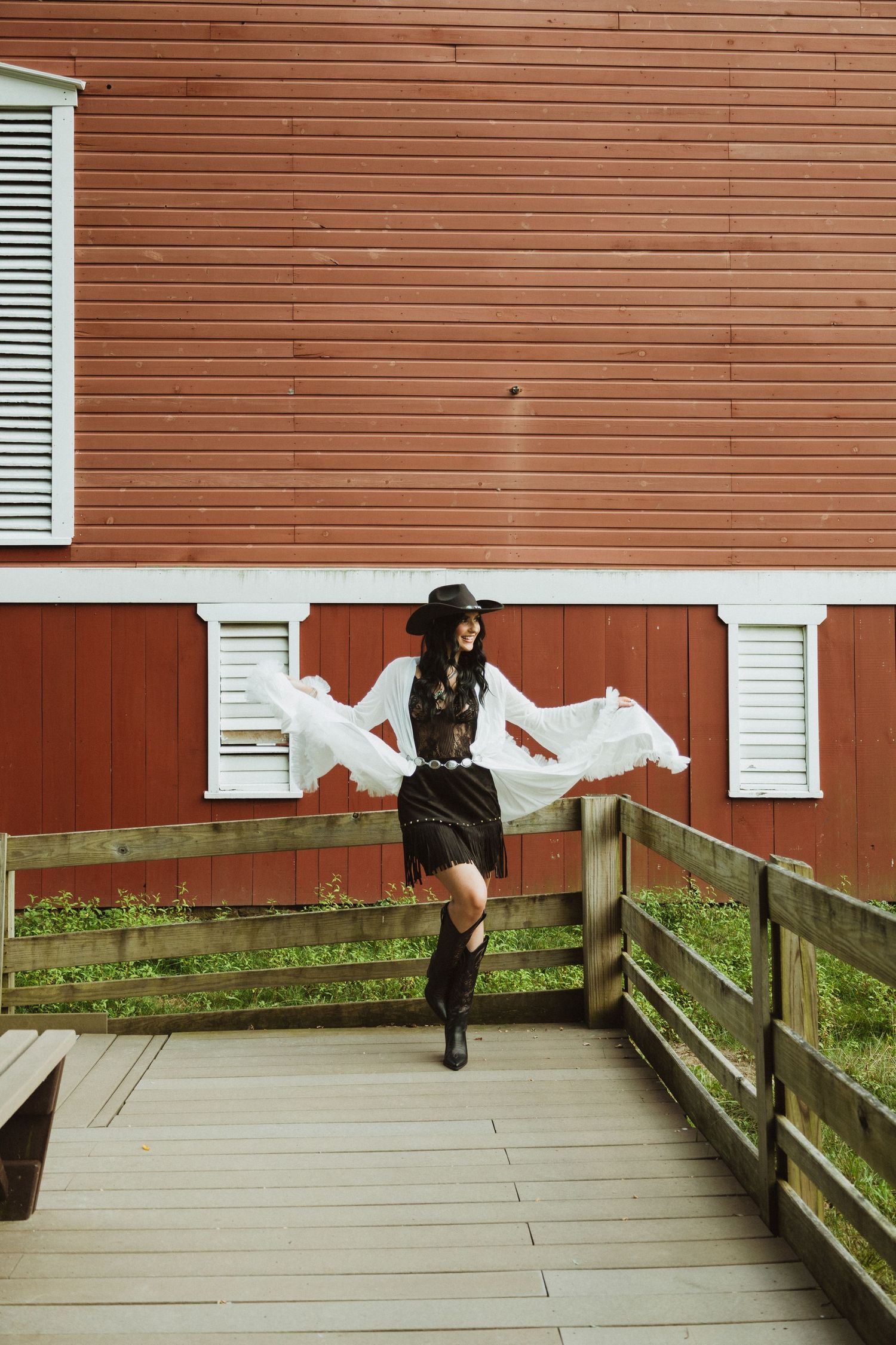 A sequence of images showing a figure in black jumping over a wooden fence in a rural setting.