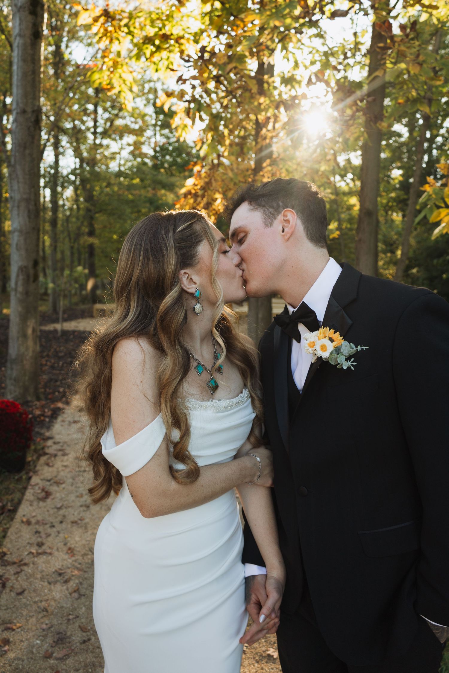 Autumn wedding portraits with golden sunlight filtering through fall foliage.
