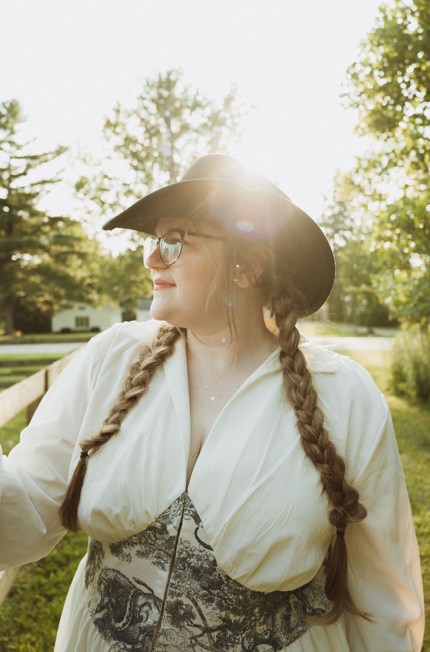 A series of sunlit portraits featuring a person in a white blouse and black hat with long braided hair in golden hour.
