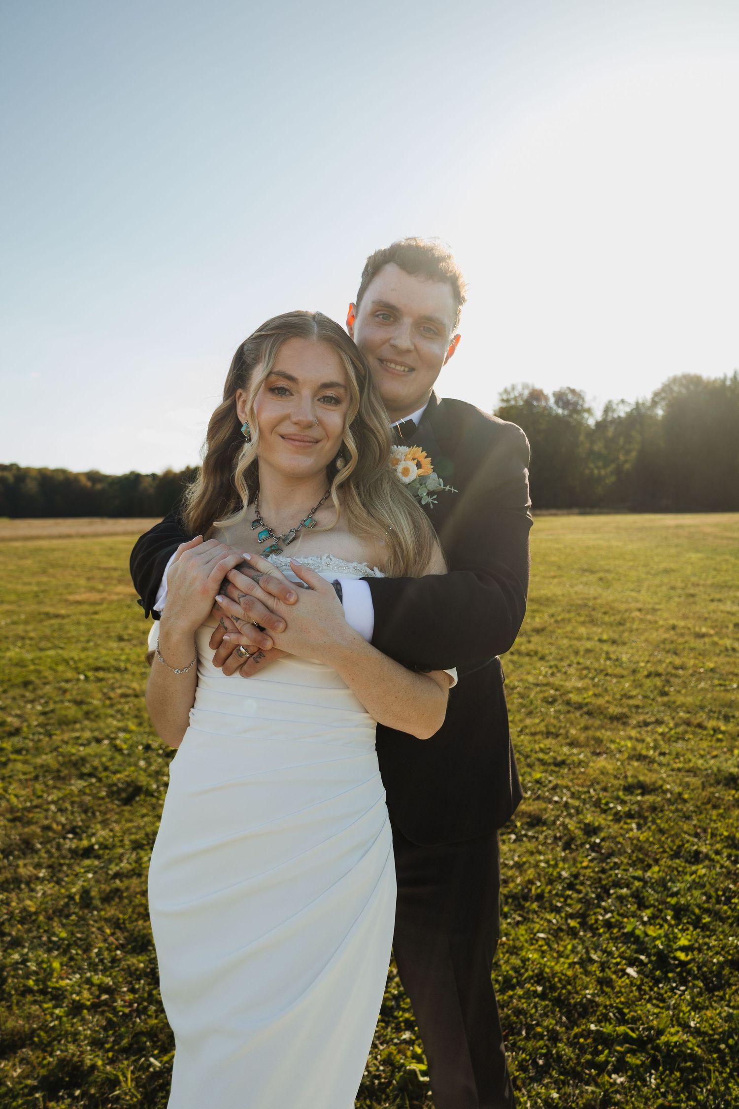 A romantic sunset portrait in a golden field on a wedding day.