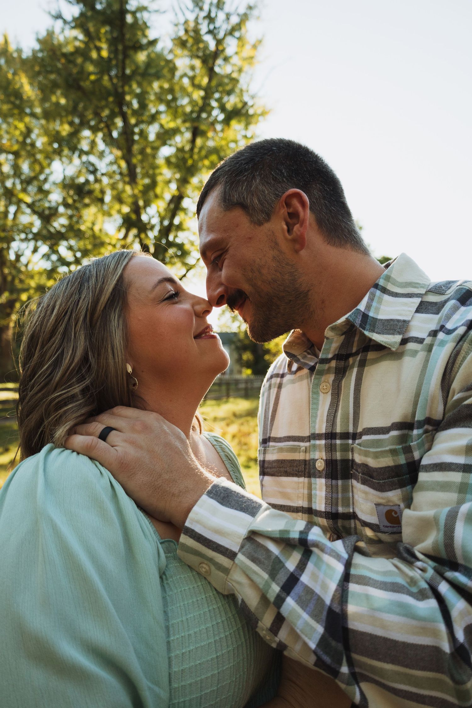 A romantic sequence of close-up shots showing a couple in a plaid shirt and mint green top sharing tender moments outdoors.