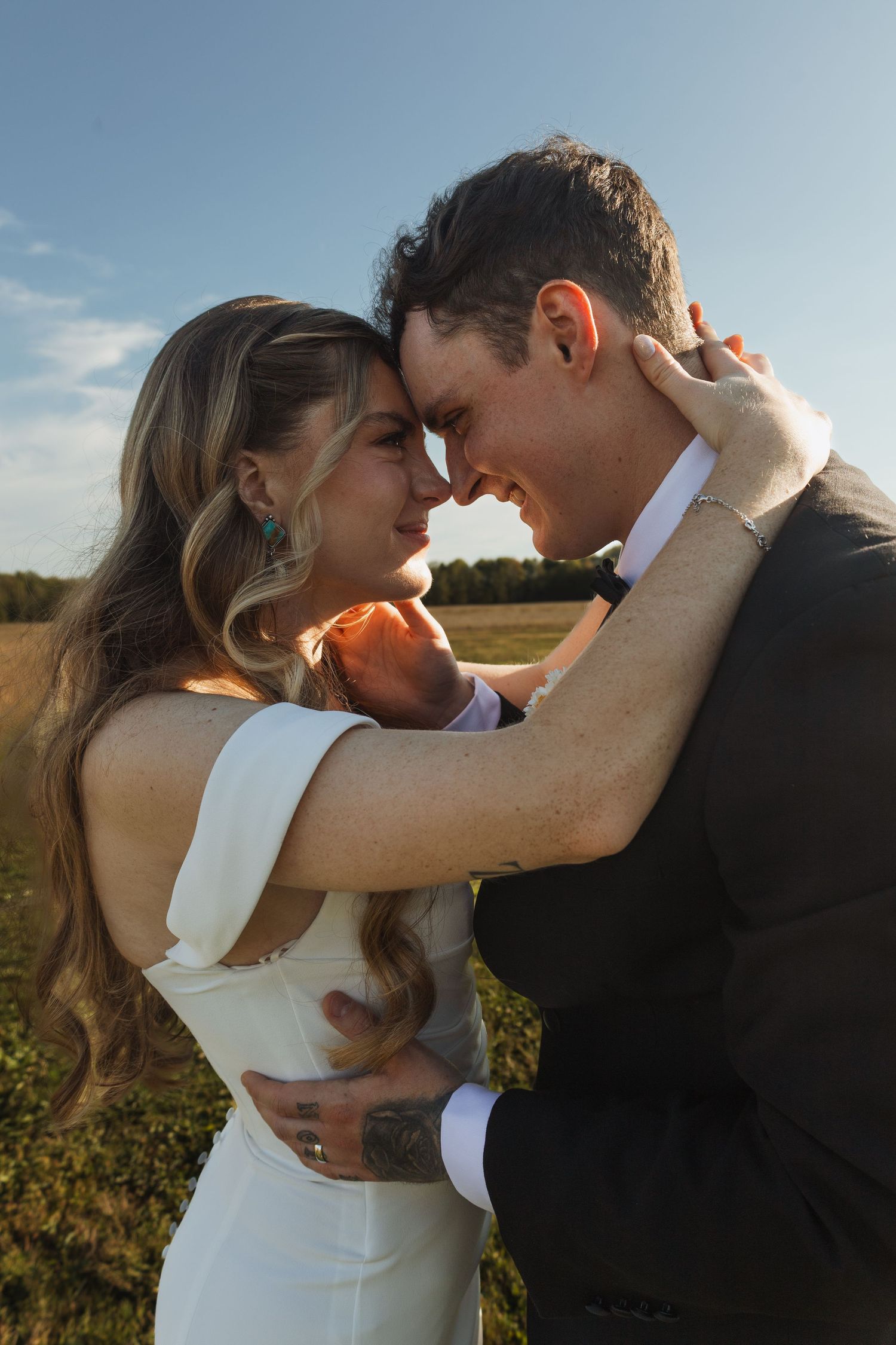 Romantic sunset moment captured in an outdoor field setting.