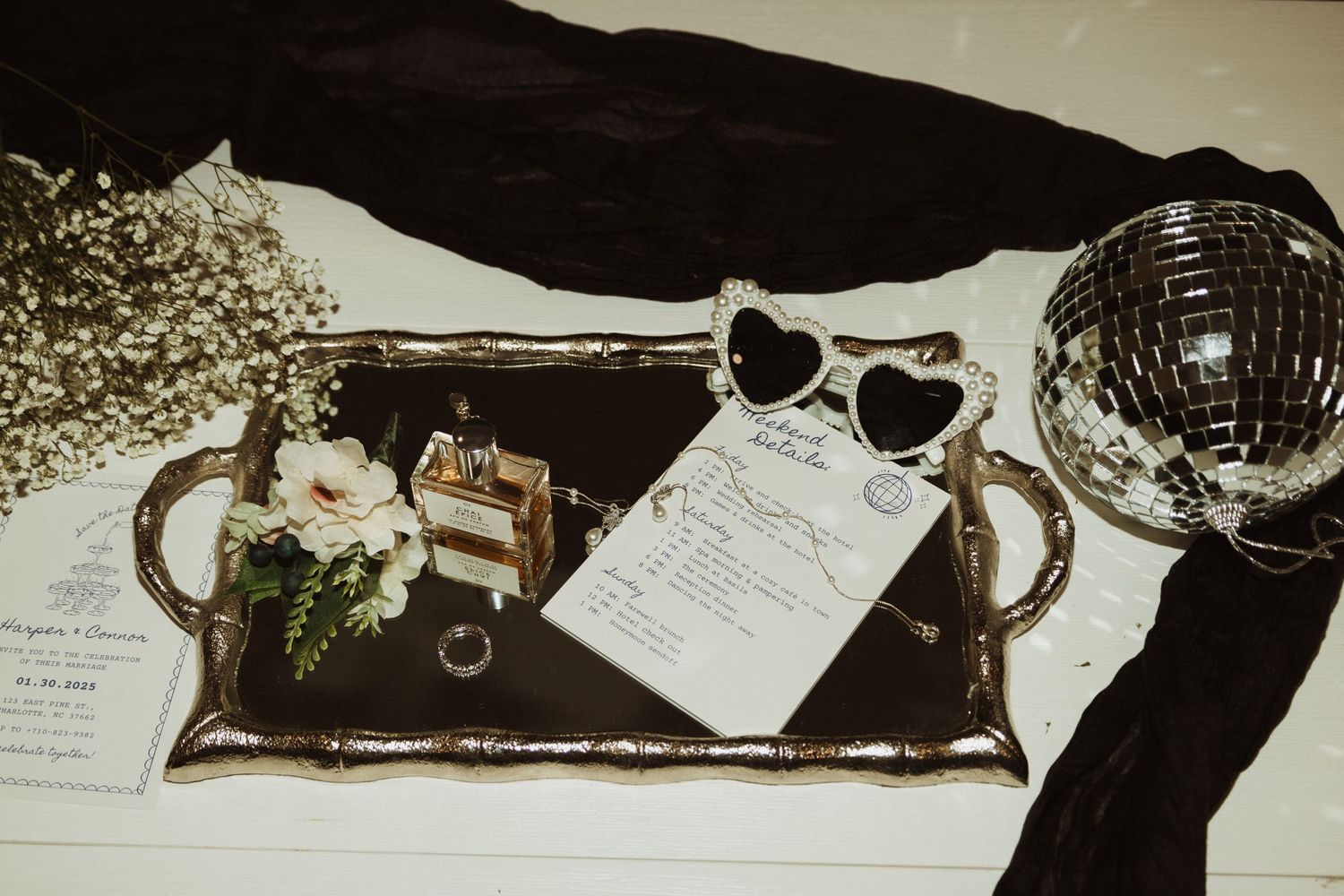 Vintage tray with wedding details, sunglasses and disco ball decoration.