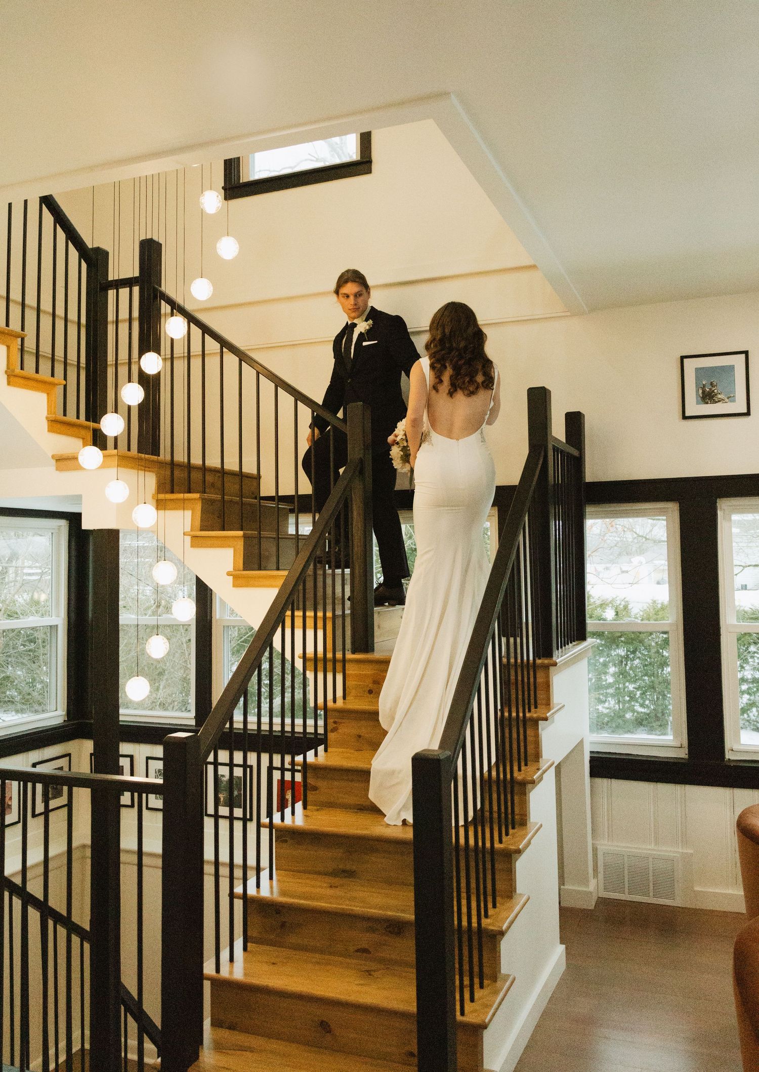Elegant staircase scene with natural light streaming through windows.
