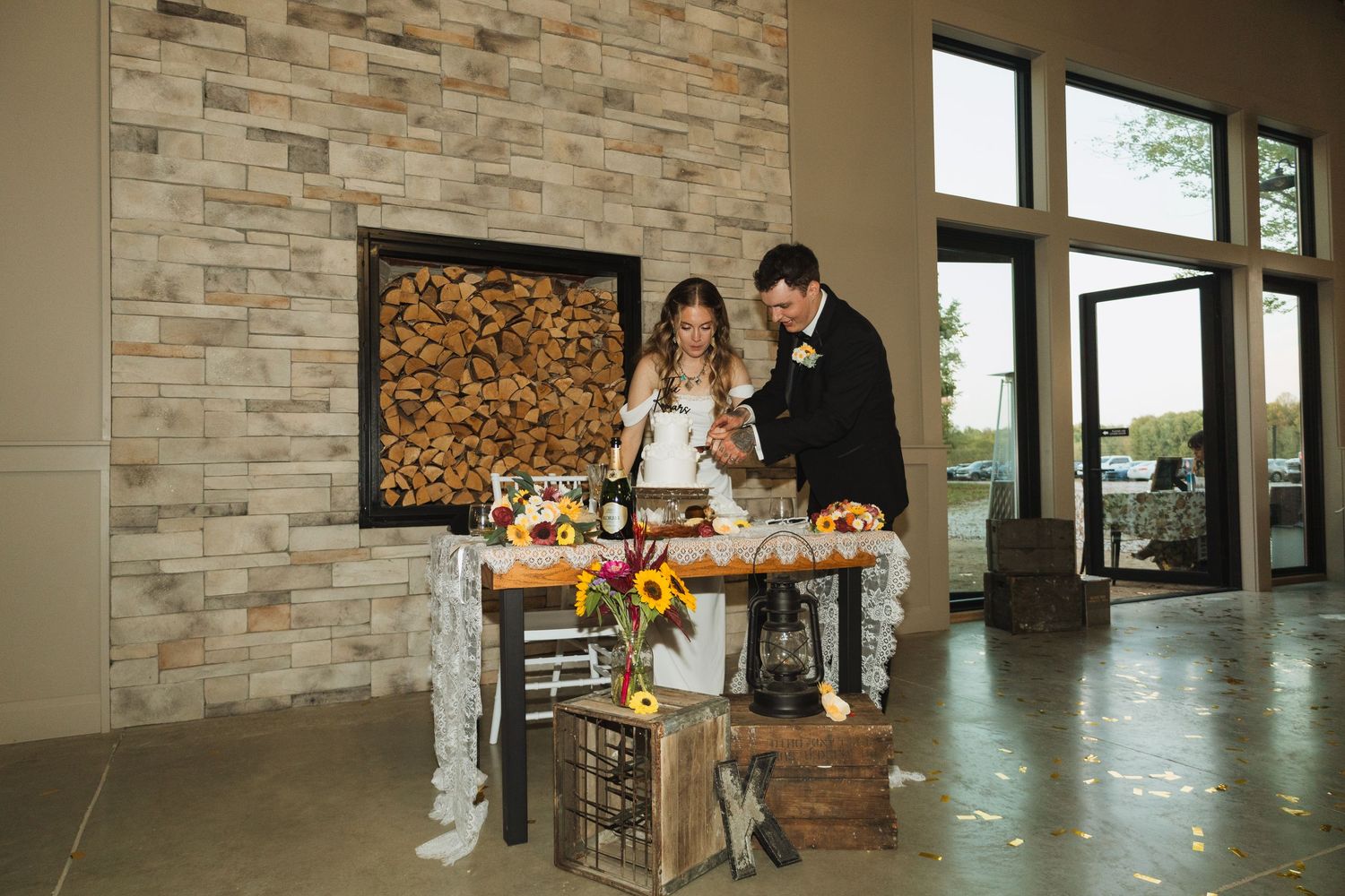 Modern stone wall interior with wooden accents and natural lighting in an elegant event space.