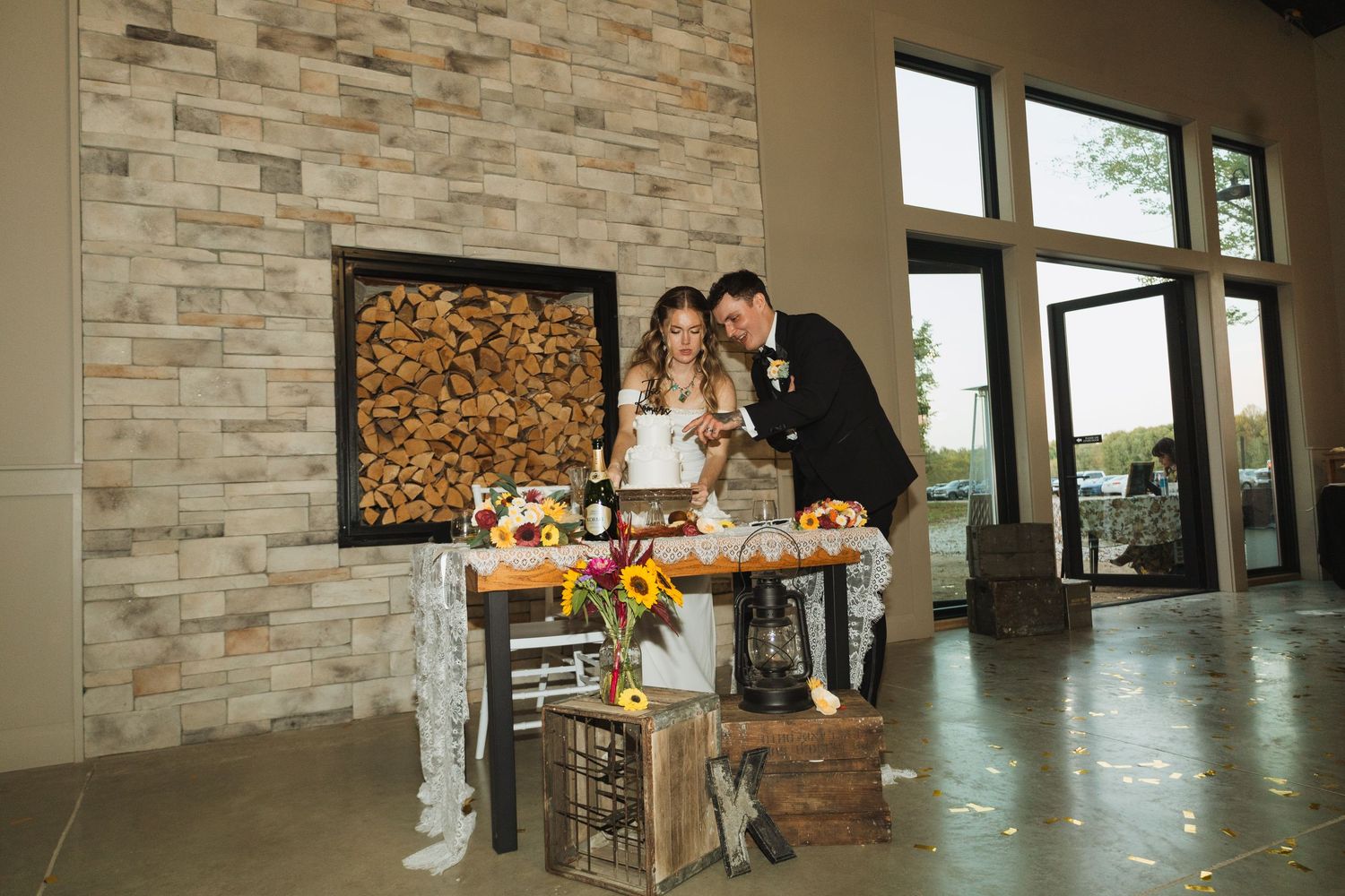 Modern indoor venue with stone accent walls and large windows overlooking natural scenery.