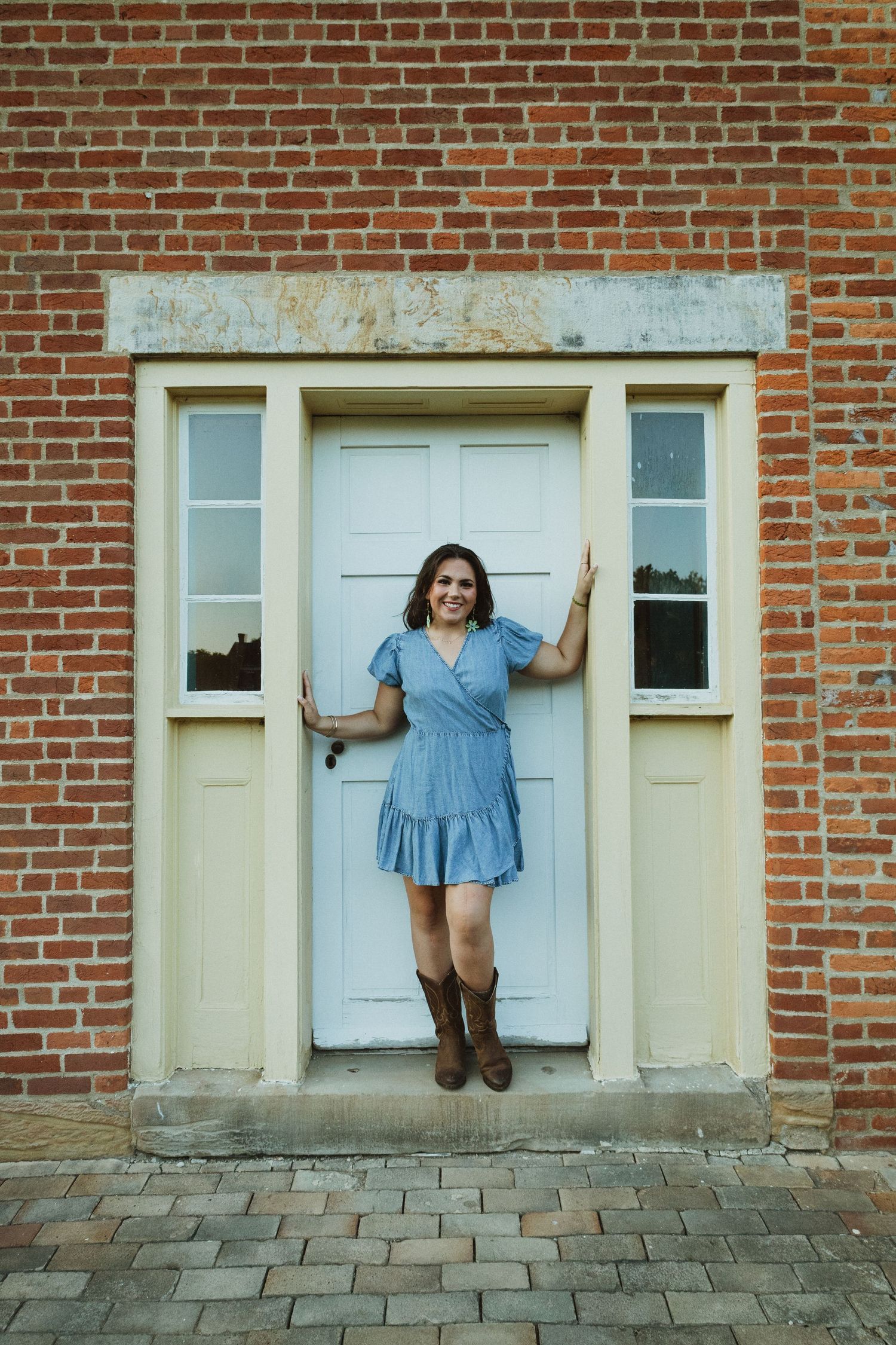 A series of photos showing someone posing playfully against a white door on a brick building exterior.