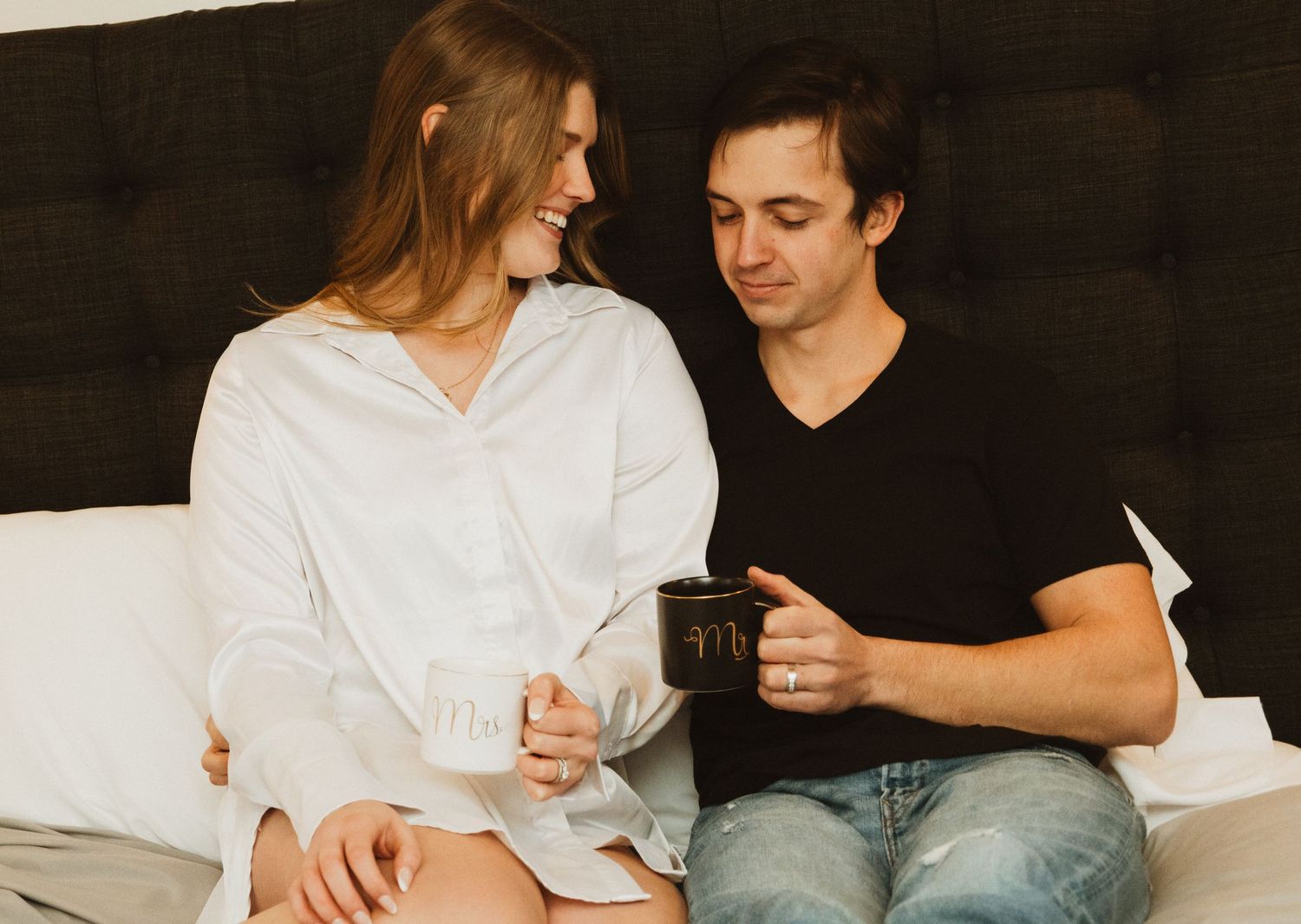 Relaxed morning scene in a modern bedroom with coffee and casual conversation.