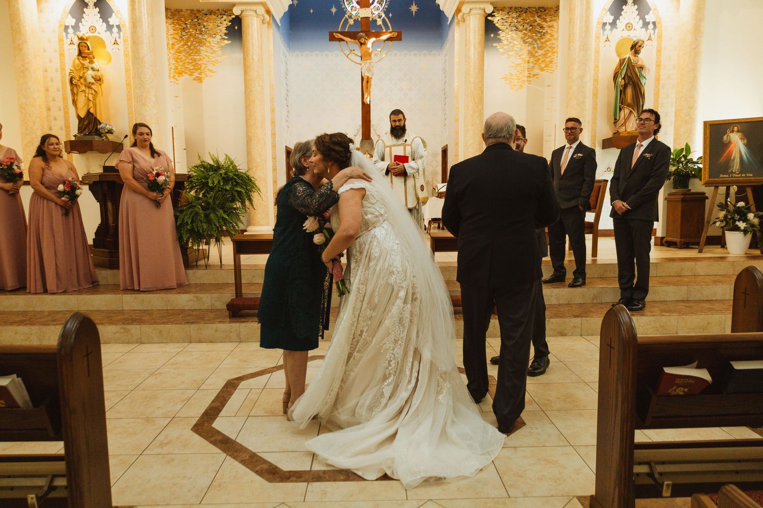 An elegant church wedding ceremony with ornate decor and stained glass windows.