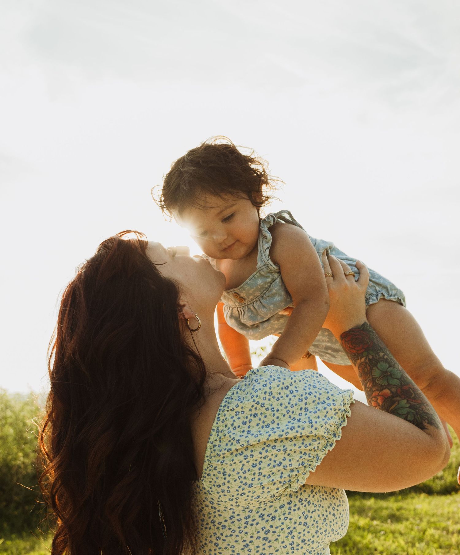 A joyful moment captured in warm sunlight on a summer evening.