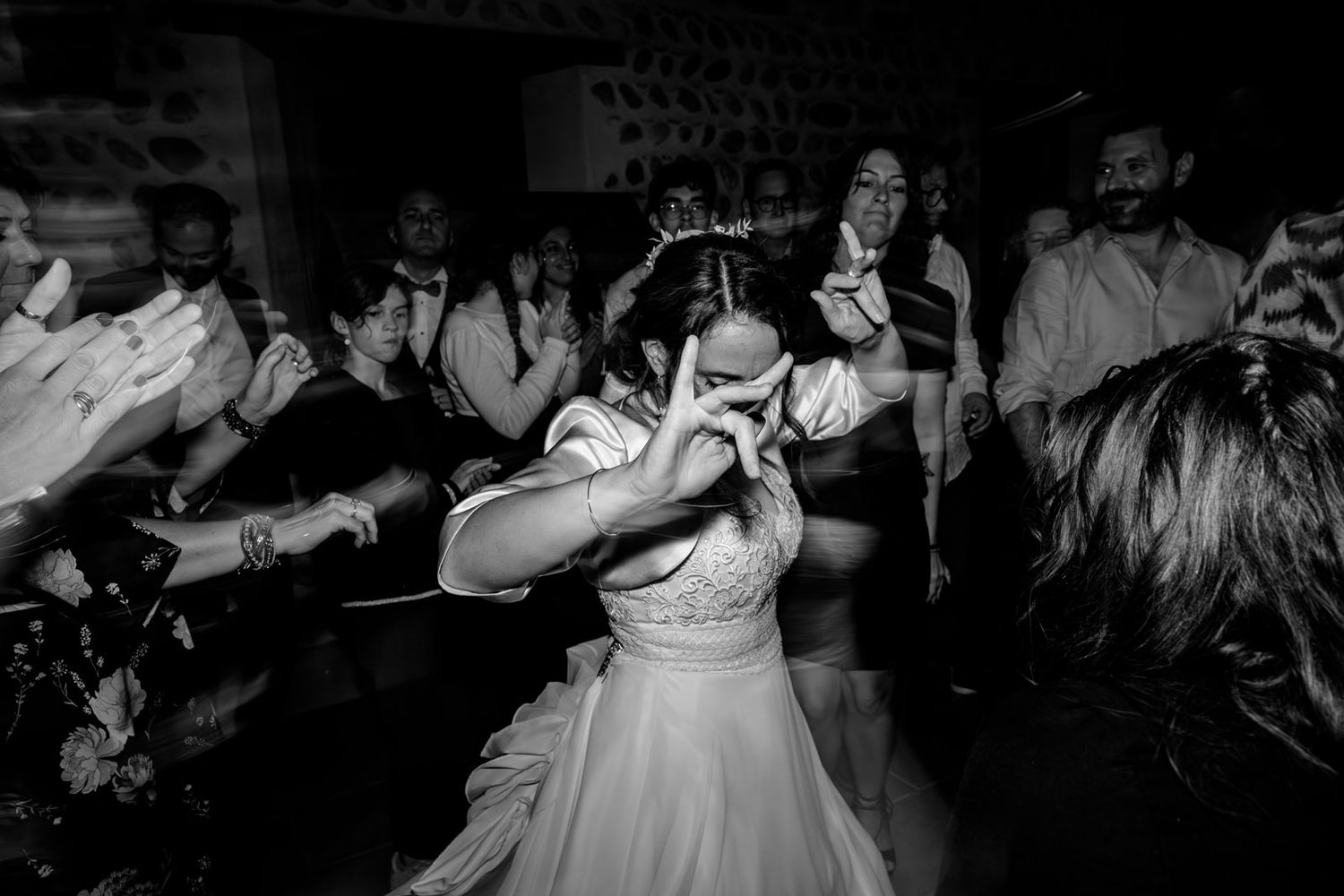 A black and white photo collage showing people dancing and celebrating at what appears to be a wedding reception.