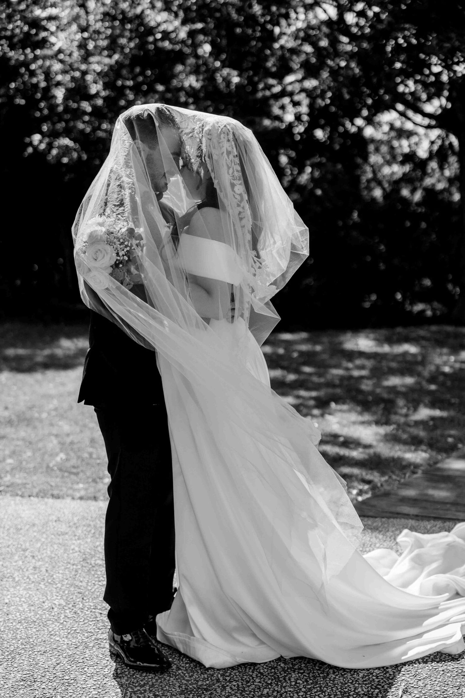 Black and white sequence of wedding dress movement and flowing veil in outdoor setting.