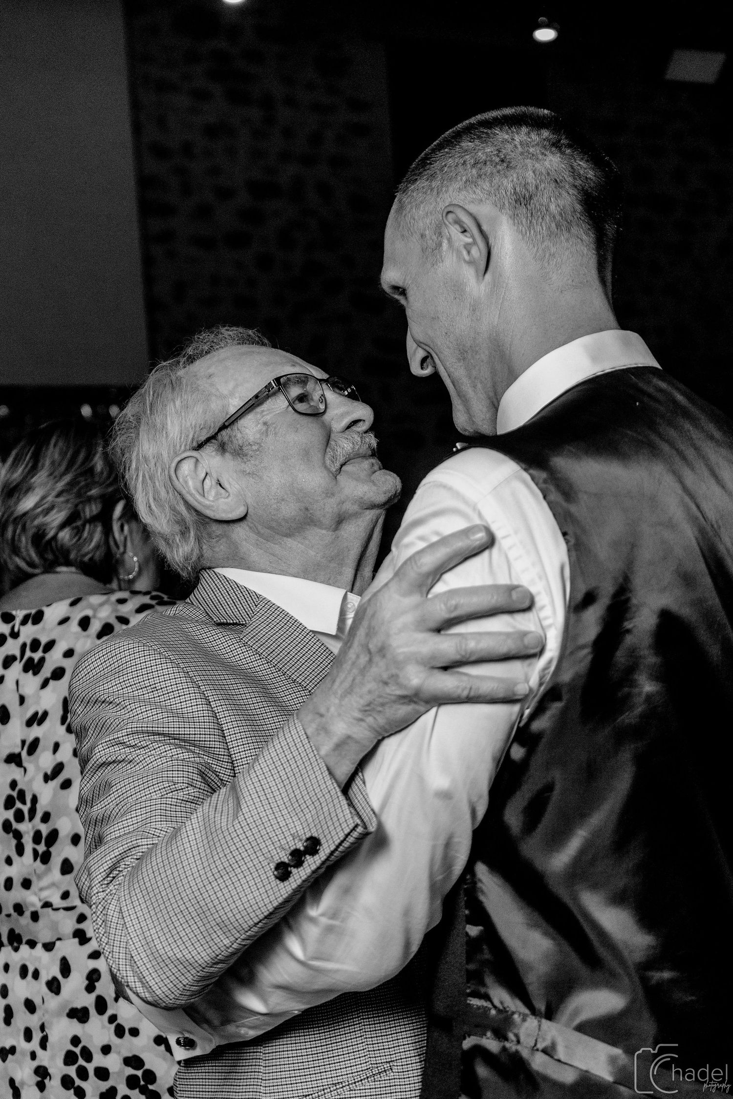 Black and white photo sequence showing a couple dancing closely in a ballroom setting.