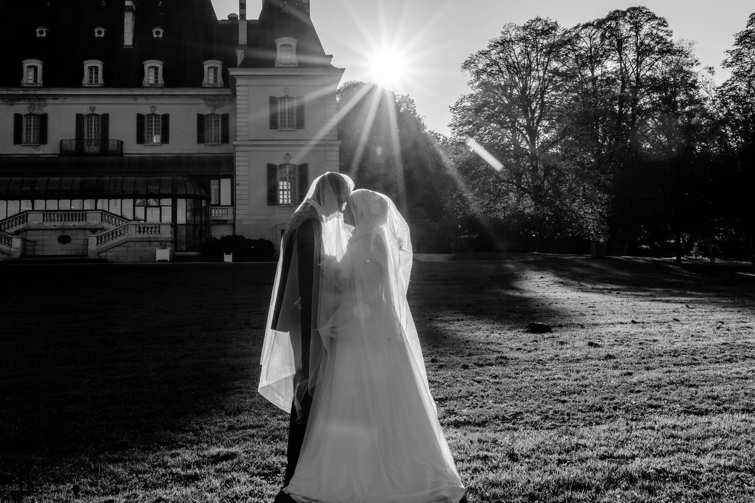 A series of black and white wedding photos showing outdoor venue scenes with sunlight and elegant formal attire.