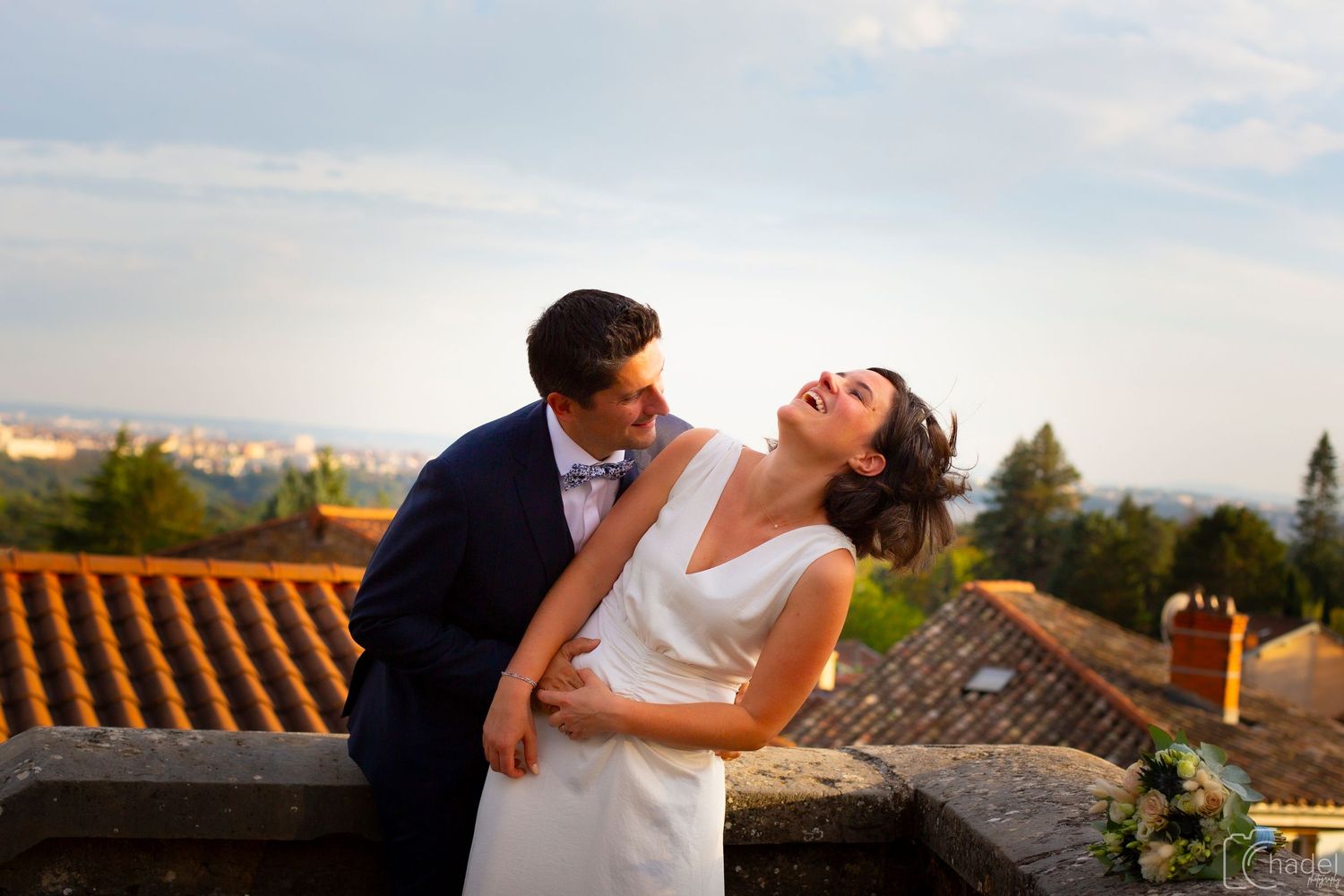Newlywed couple sharing romantic moments at sunset in a Mediterranean villa setting.
