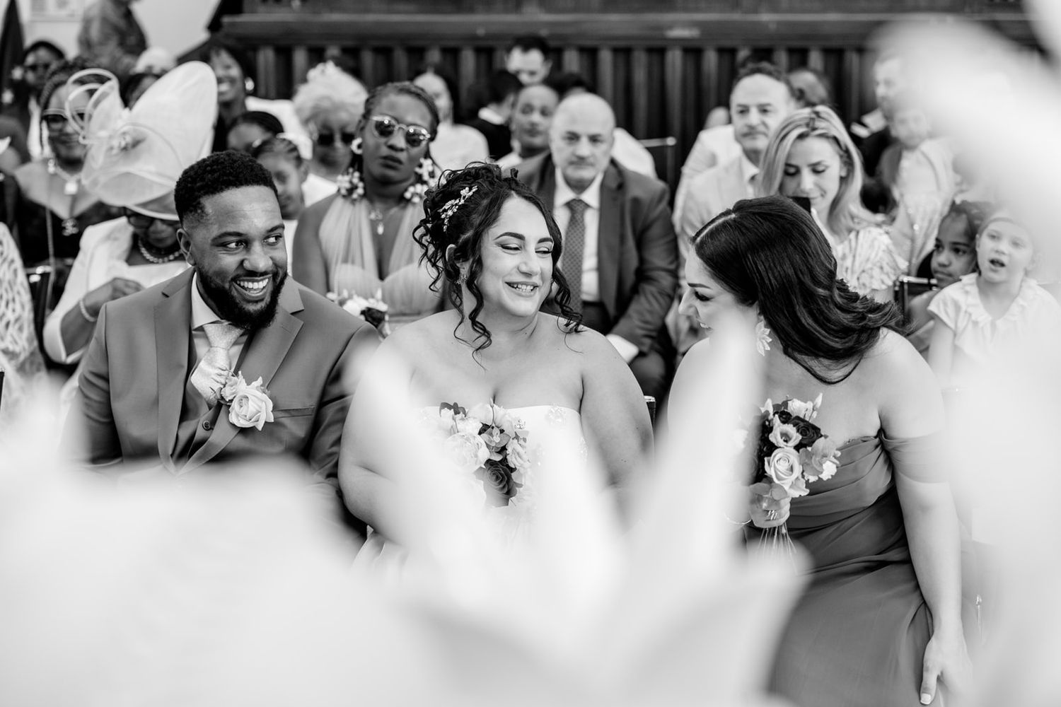 A series of candid black and white photos showing guests enjoying themselves at a wedding reception.