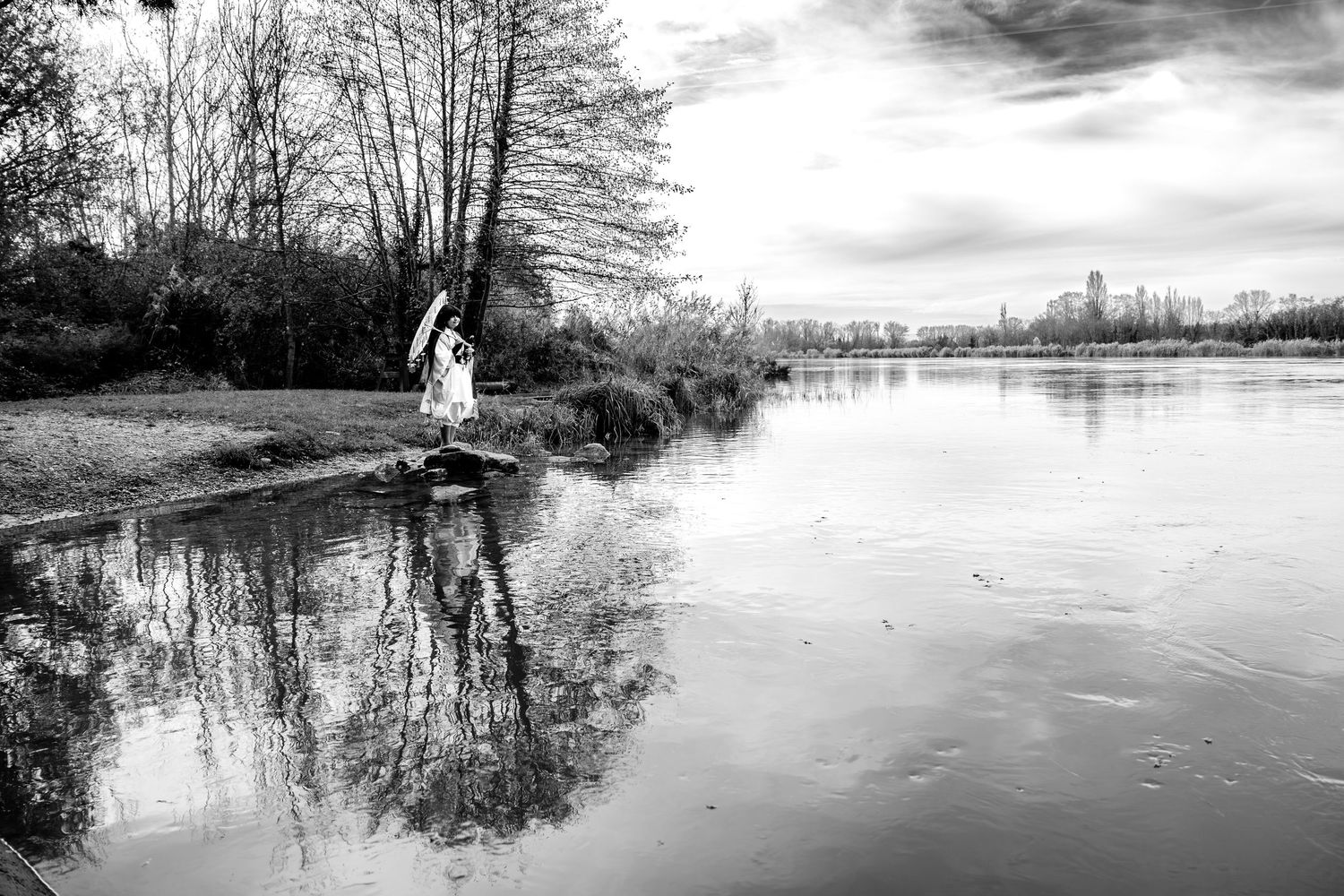 Black and white panoramic landscape shots of a winter lake scene with reflections.