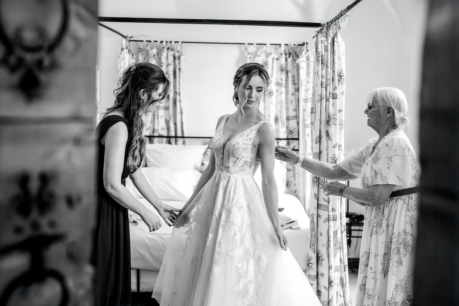 A series of black and white wedding preparation photos showing a bride getting ready in a traditional white gown.