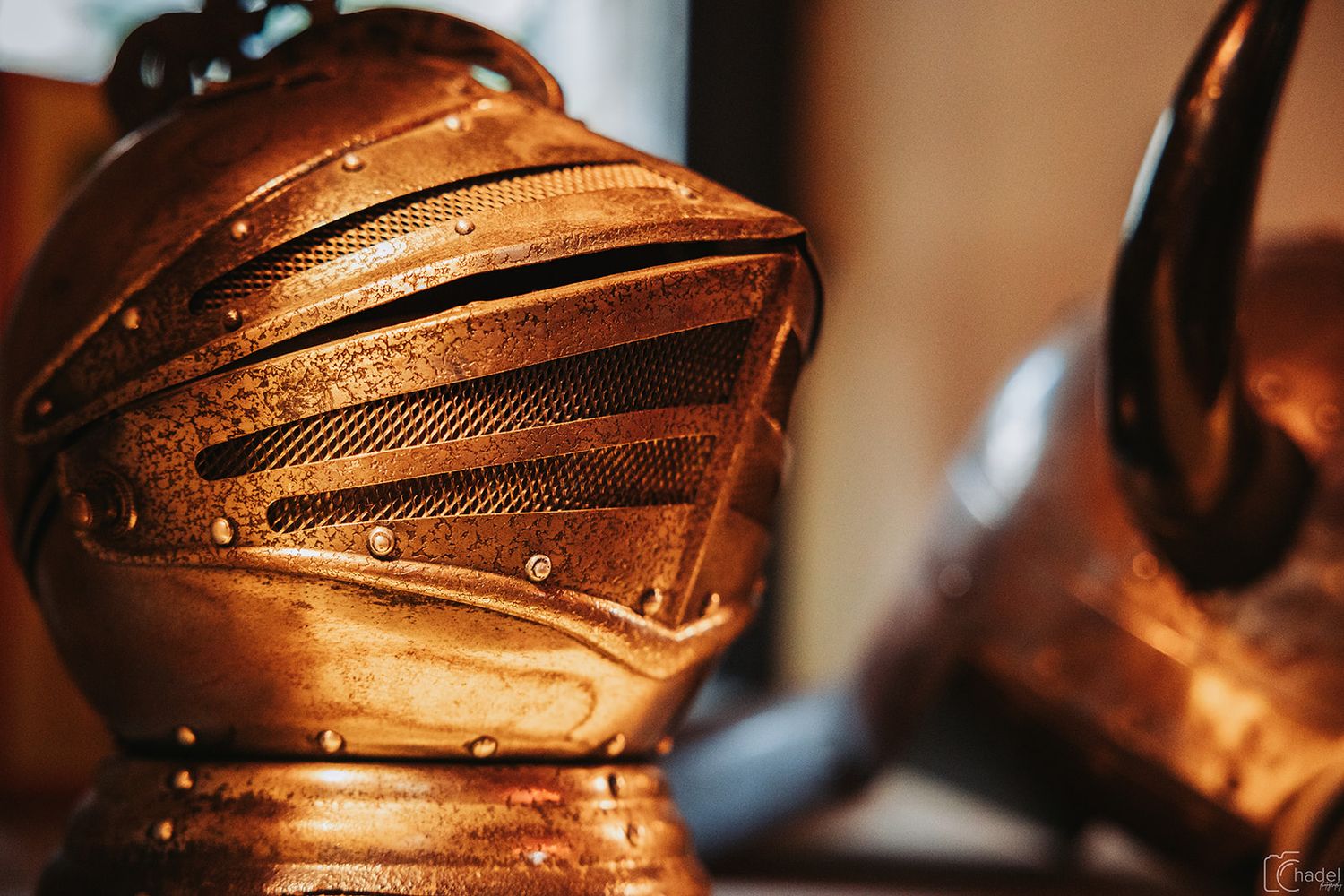 A row of copper-colored motorcycle helmets lined up on display showing their sleek design and metallic finish.