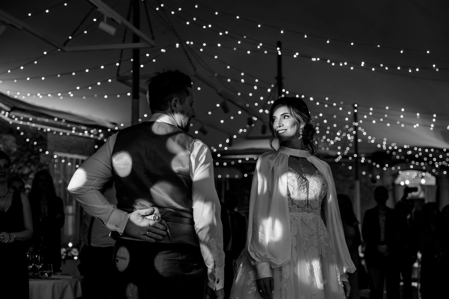 Wedding reception venue decorated with romantic string lights creating a magical atmosphere.
