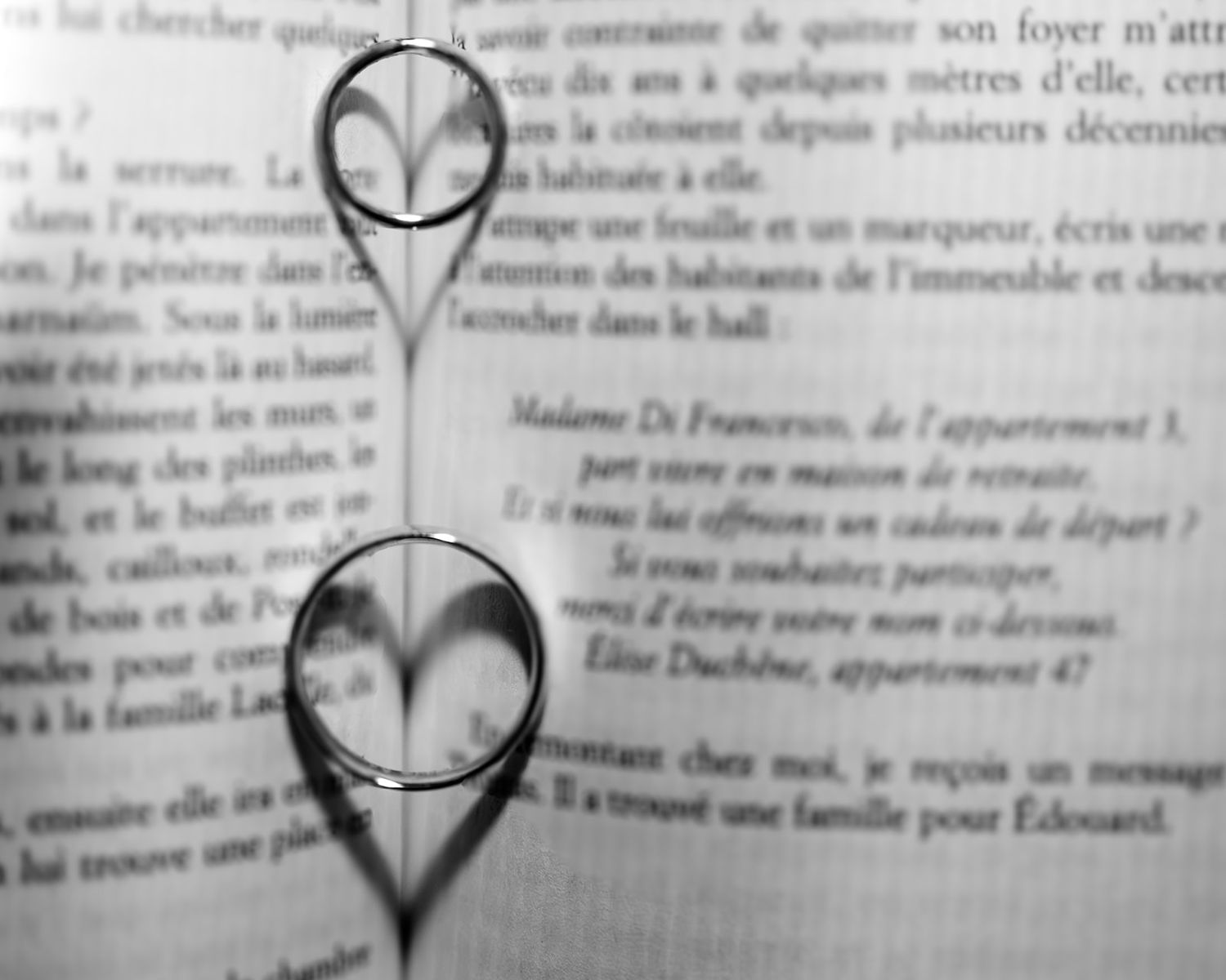 A heart shape drawn in black ink over text on a book or document page.