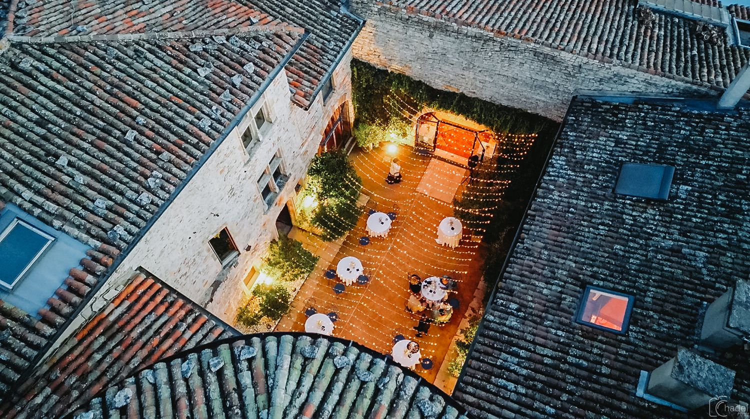 Aerial view of traditional Chinese rooftops with gray tiles and curved architecture in an ancient village.