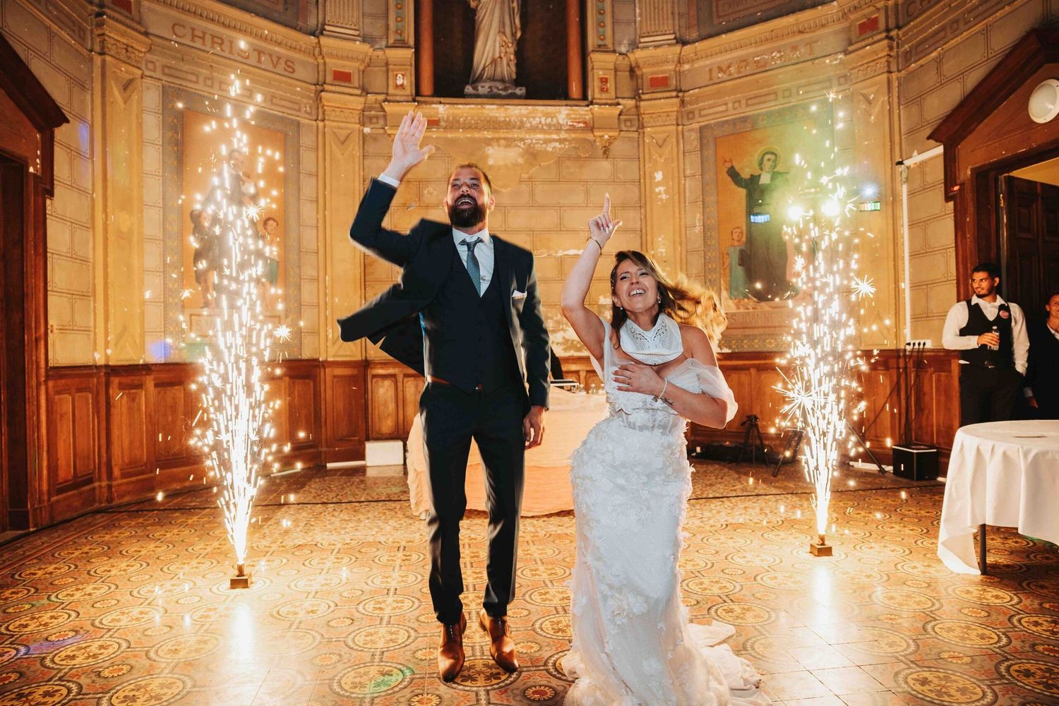 Wedding celebration with sparkler fountains illuminating an elegant ballroom dance floor.
