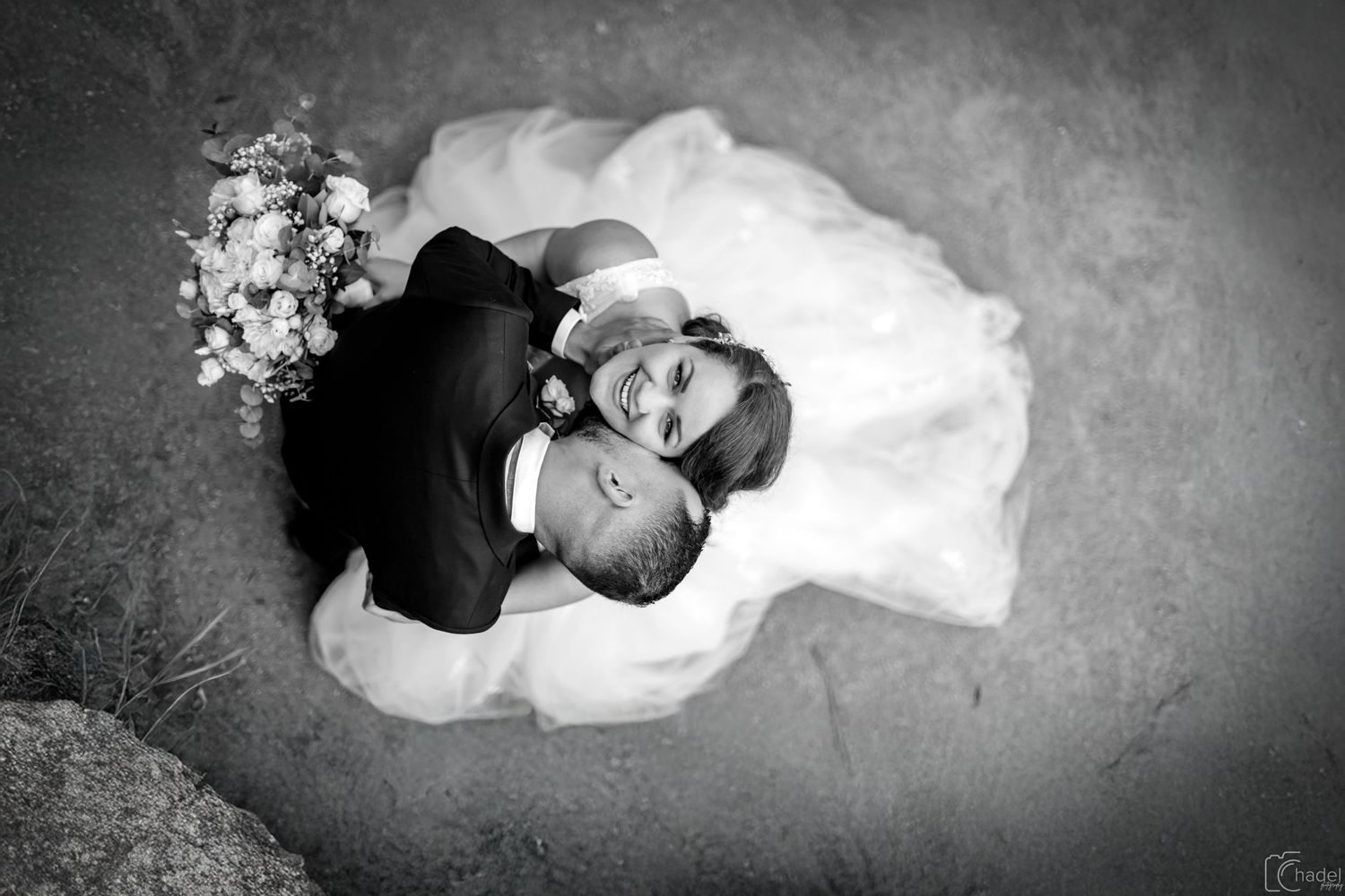 Black and white artistic overhead shots of a couple in wedding attire on textured background.