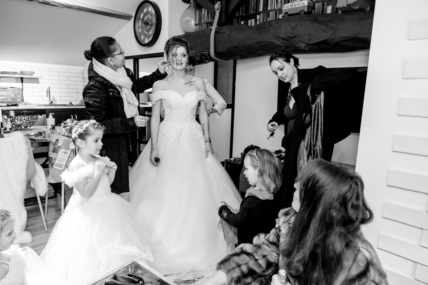Black and white collage of wedding preparation moments showing dress fitting and getting ready scenes.