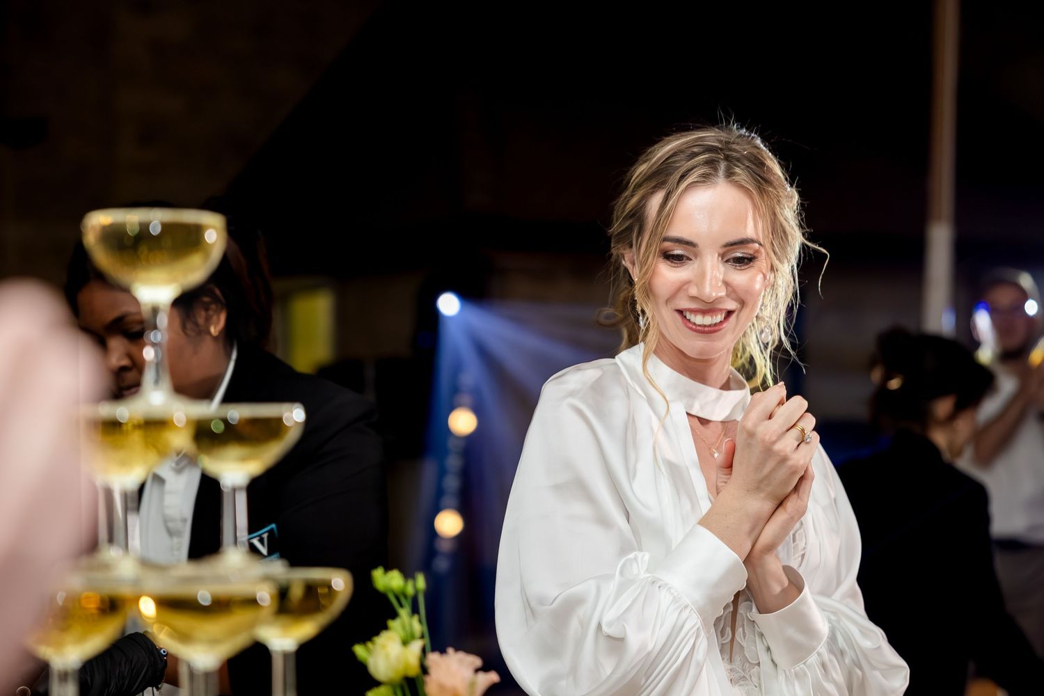 Elegant champagne glasses and table settings at a wedding reception.