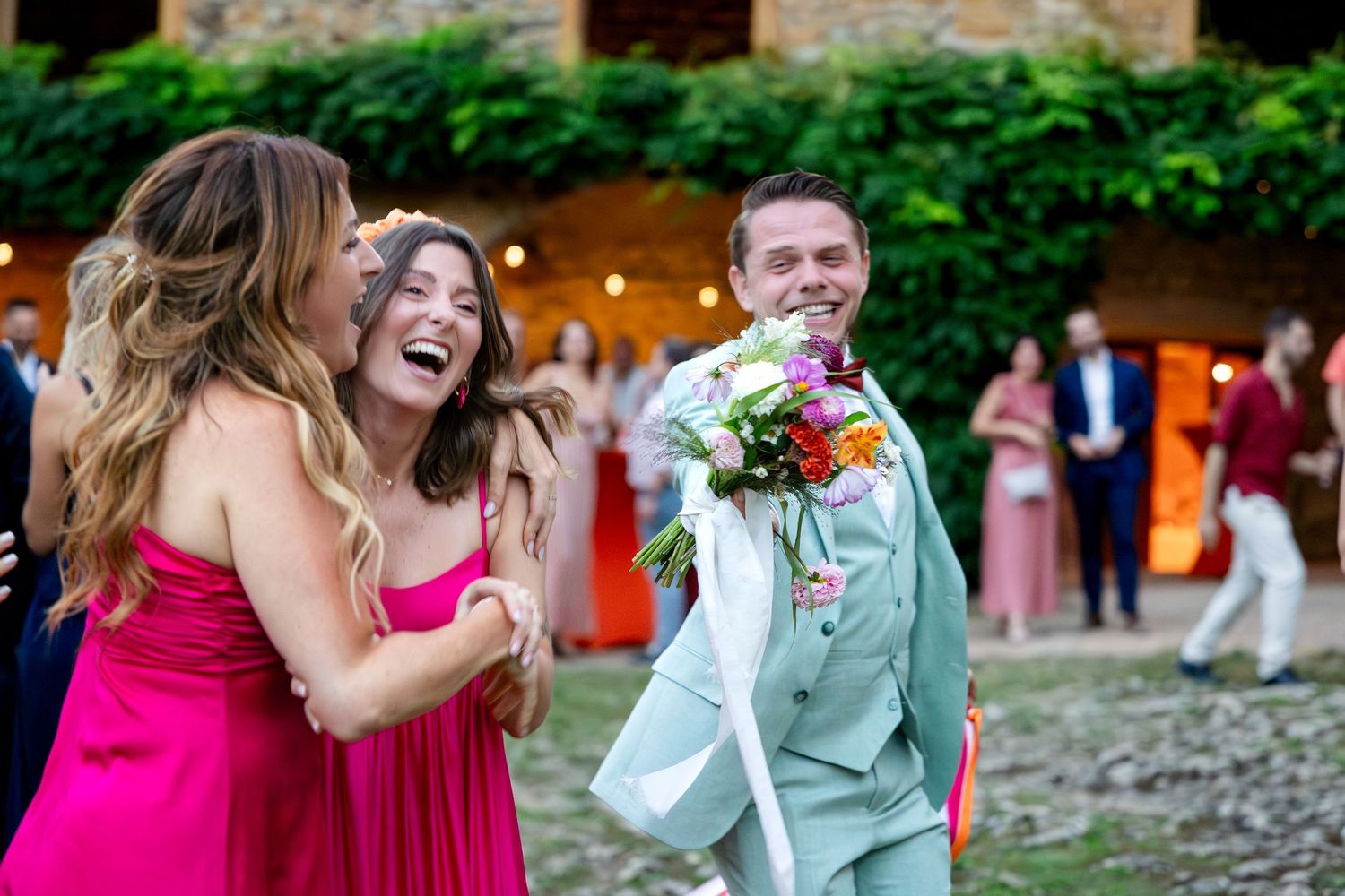 Joyful celebration at an outdoor garden party with festive lighting.