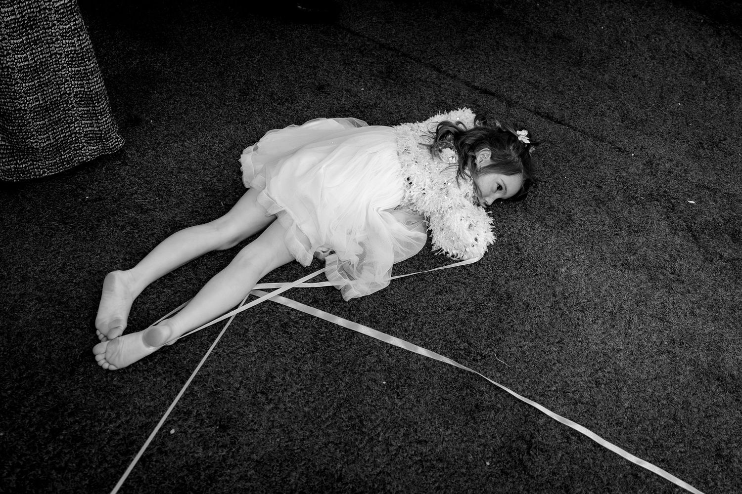 A series of black and white photos showing someone lying on the ground in different poses.