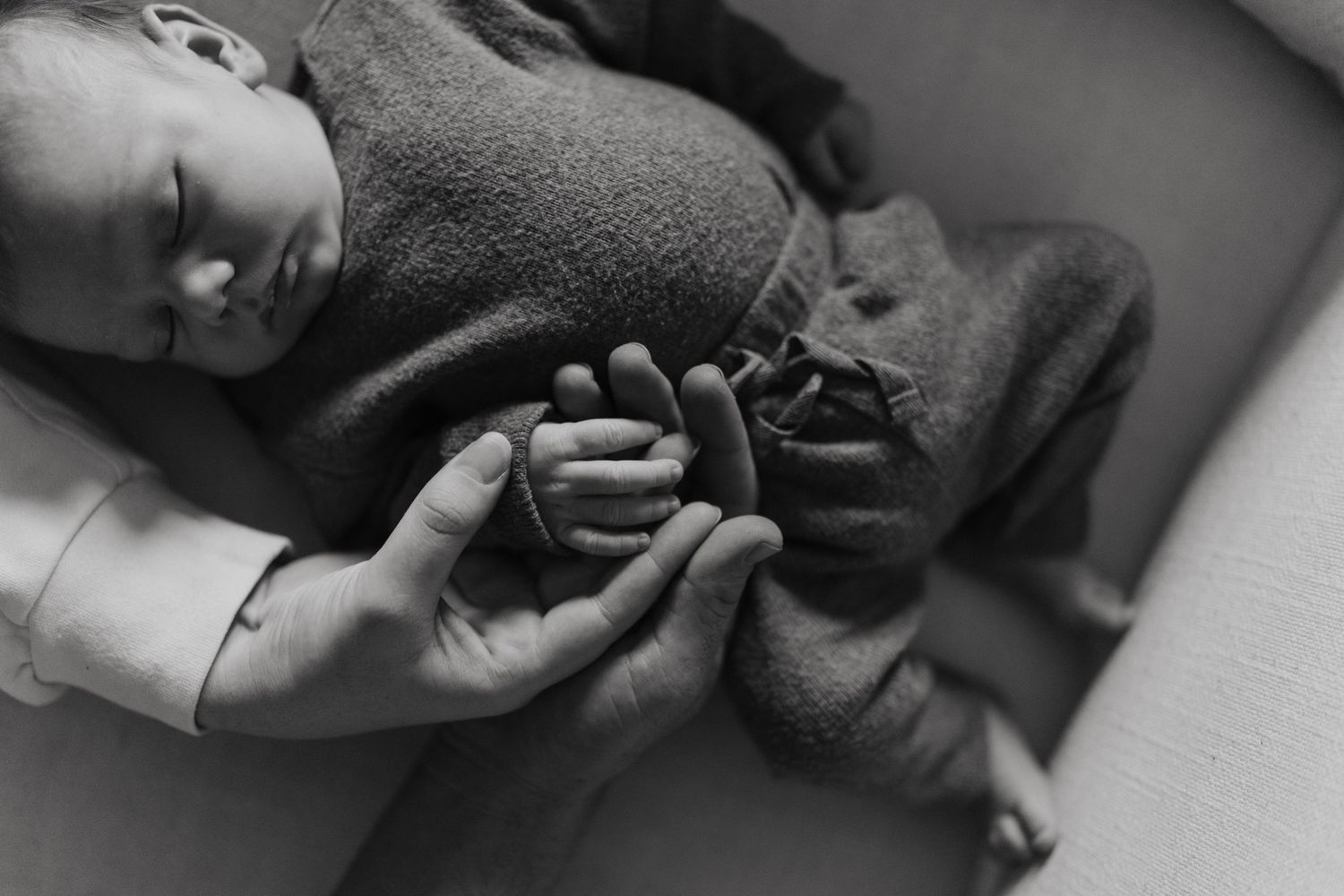 Close-up black and white portrait of sleeping newborn.