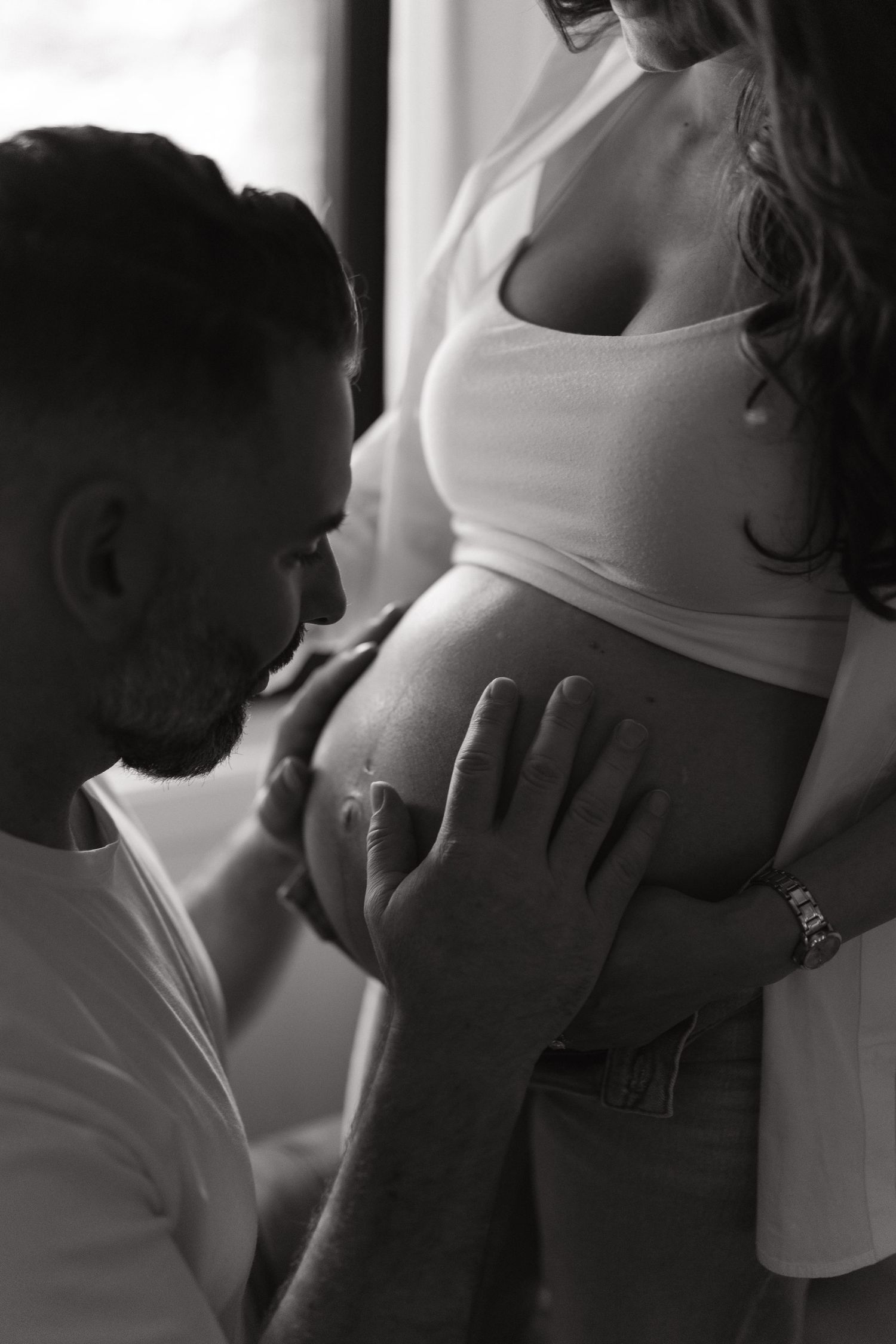 Black and white intimate maternity photos showing tender moments.