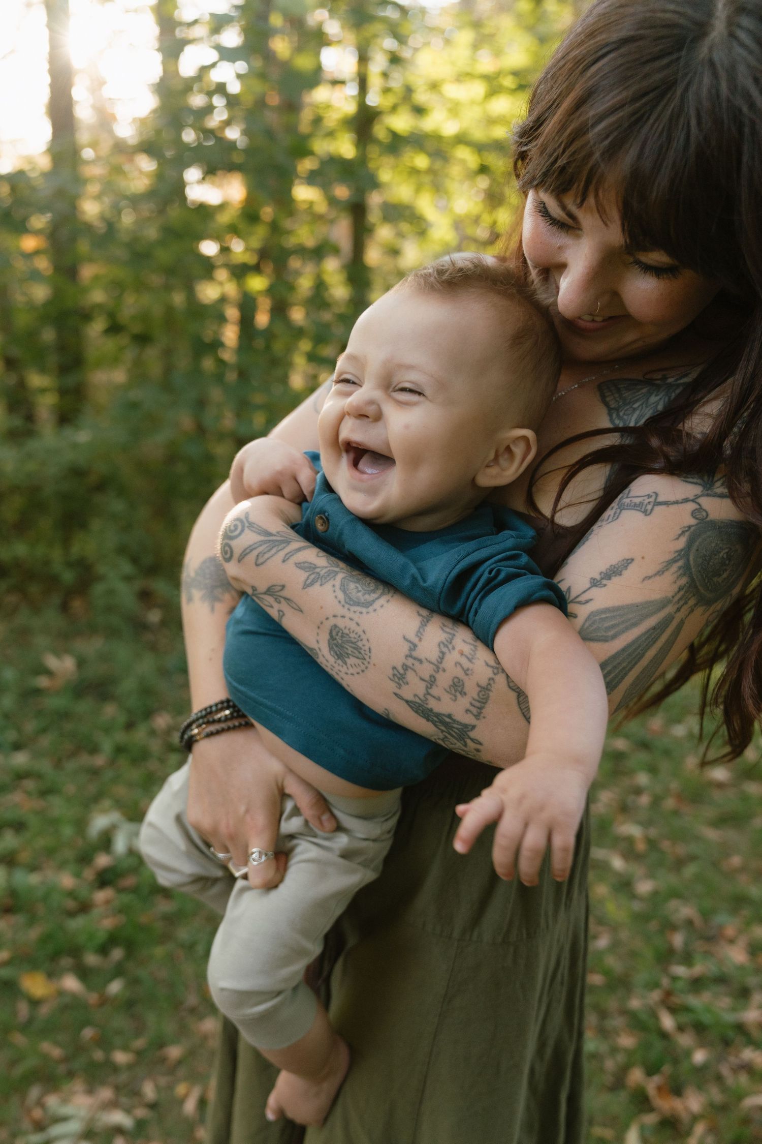 Joyful moment between parent and child in forest setting.