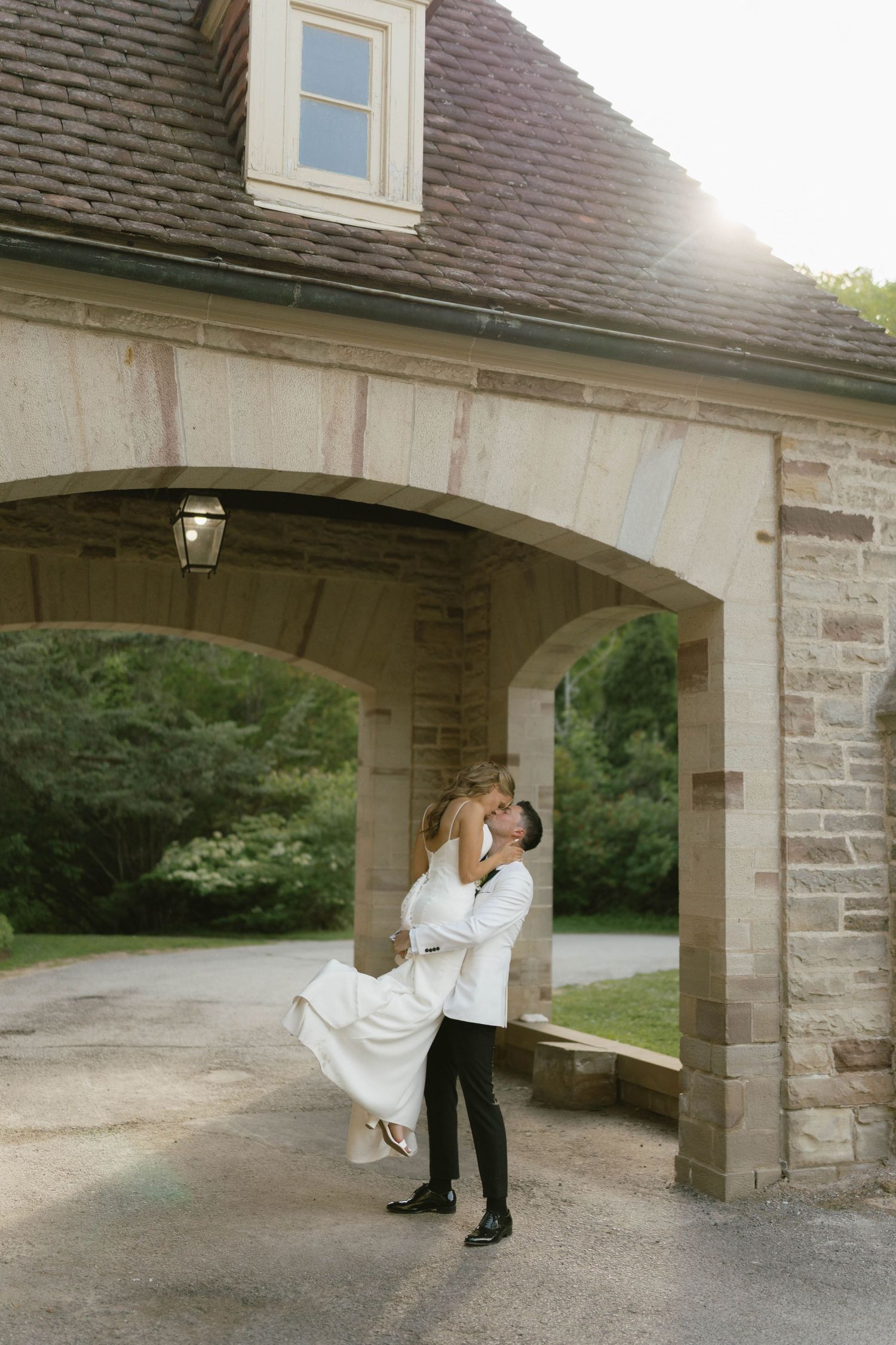 A romantic dance sequence under a stone archway showcases elegant movements in black and white attire.