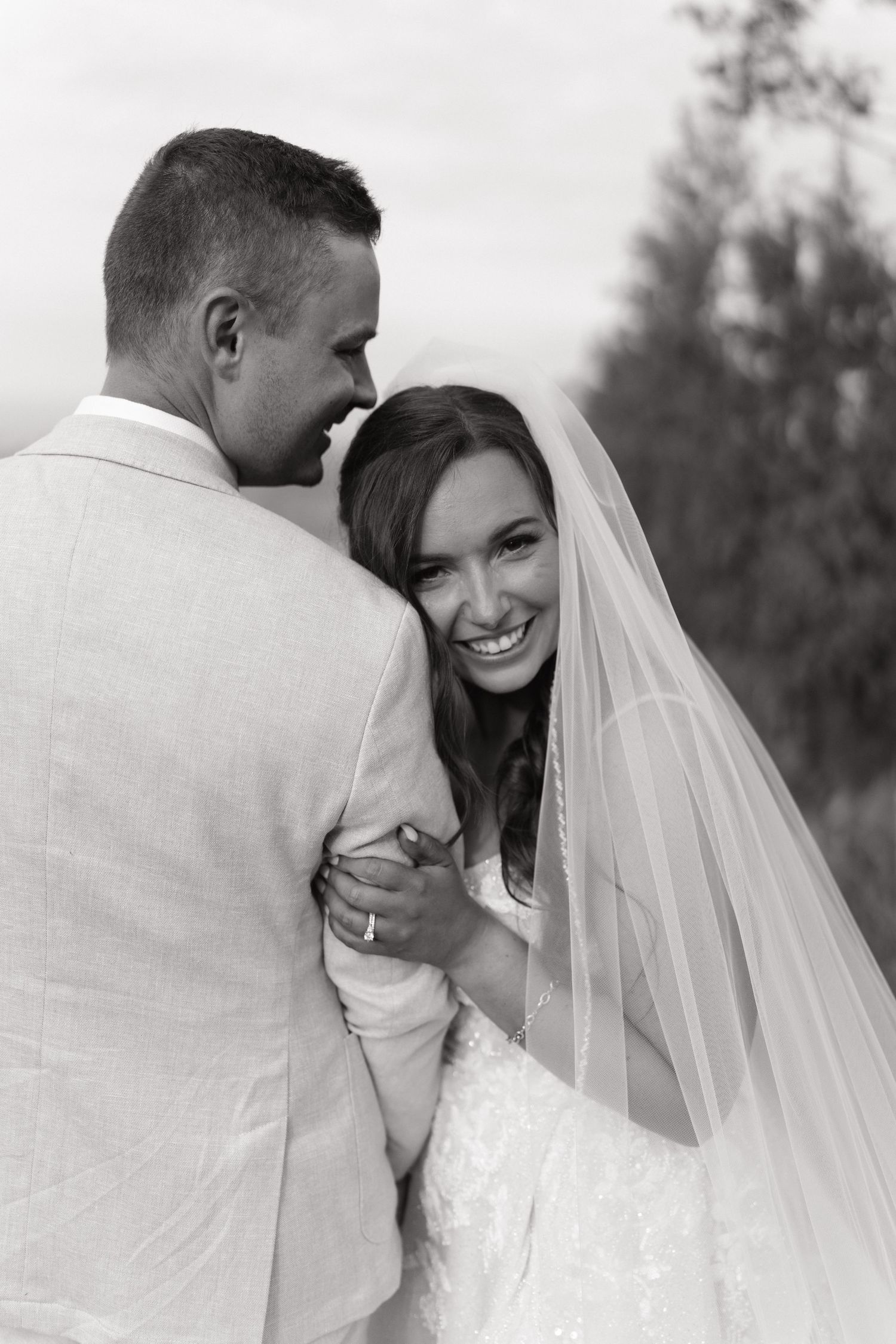 Black and white wedding portraits showing intimate moments between newlyweds.