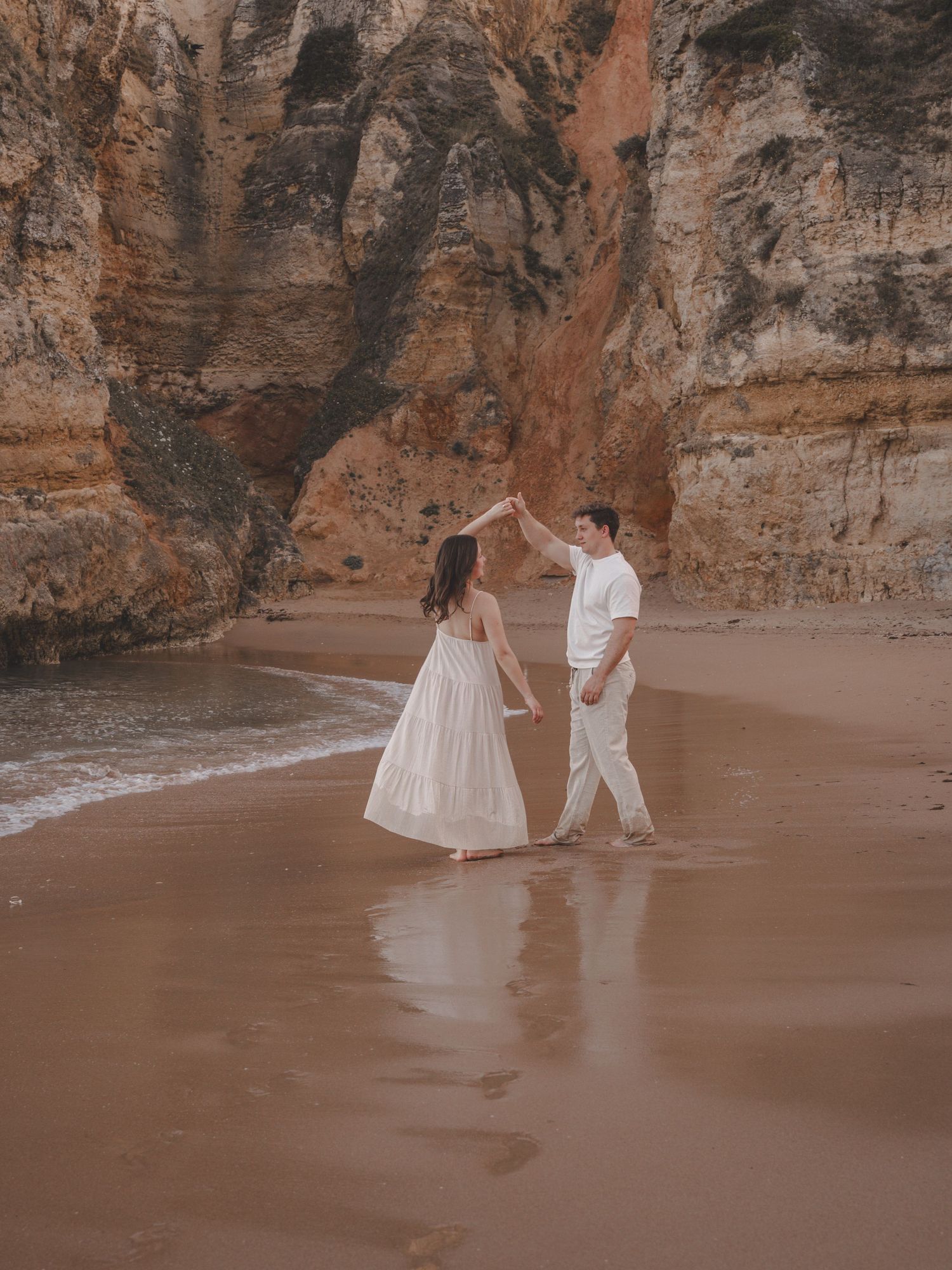 Natural couple photography session on the golden cliffs of Praia Dona Ana, Lagos, Portugal
