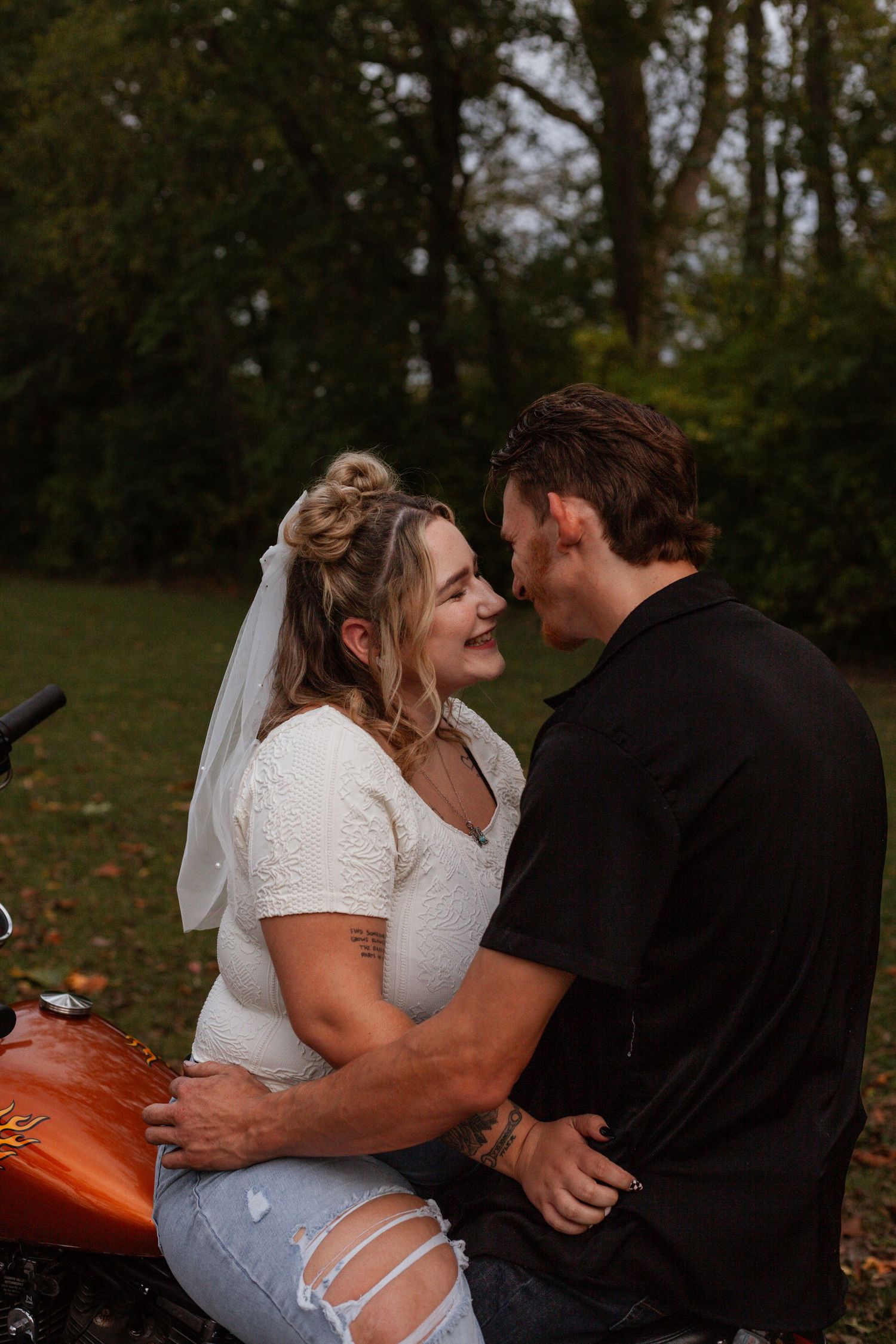 Romantic couple sharing an intimate moment on a pumpkin patch during autumn.