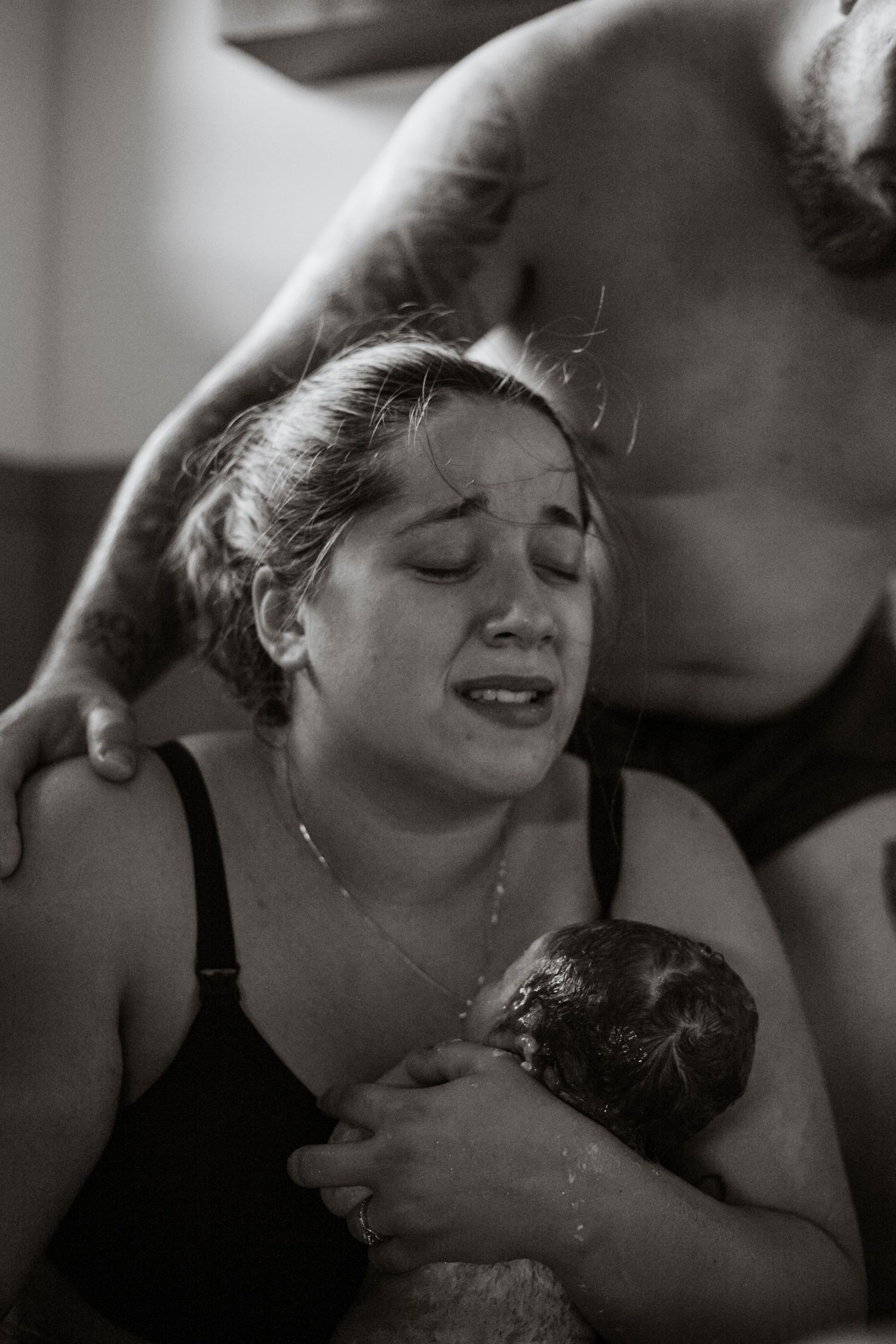 Black and white sequence capturing raw emotional expressions during childbirth.