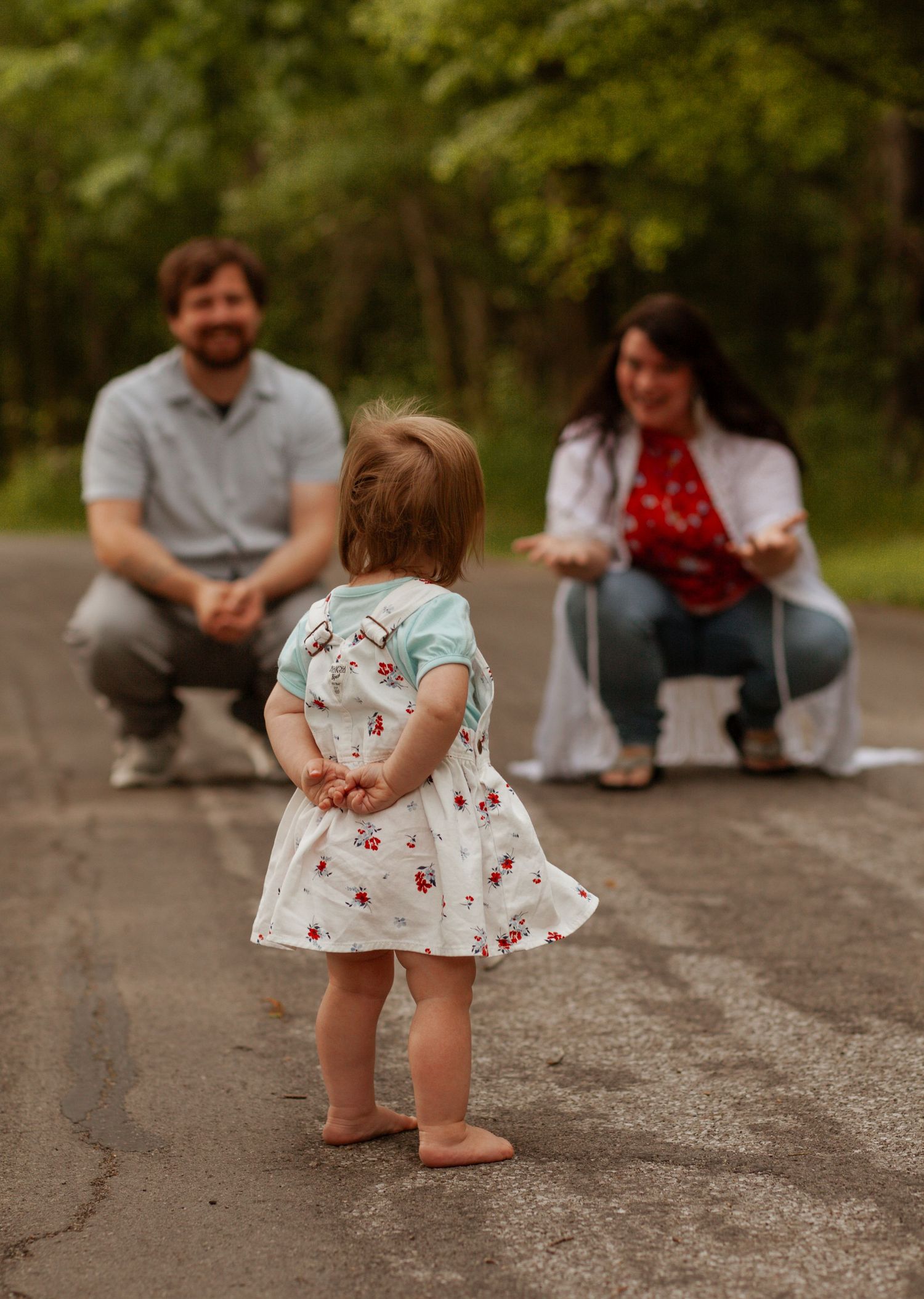 A sequence showing a small child exploring and walking on a paved path outdoors.