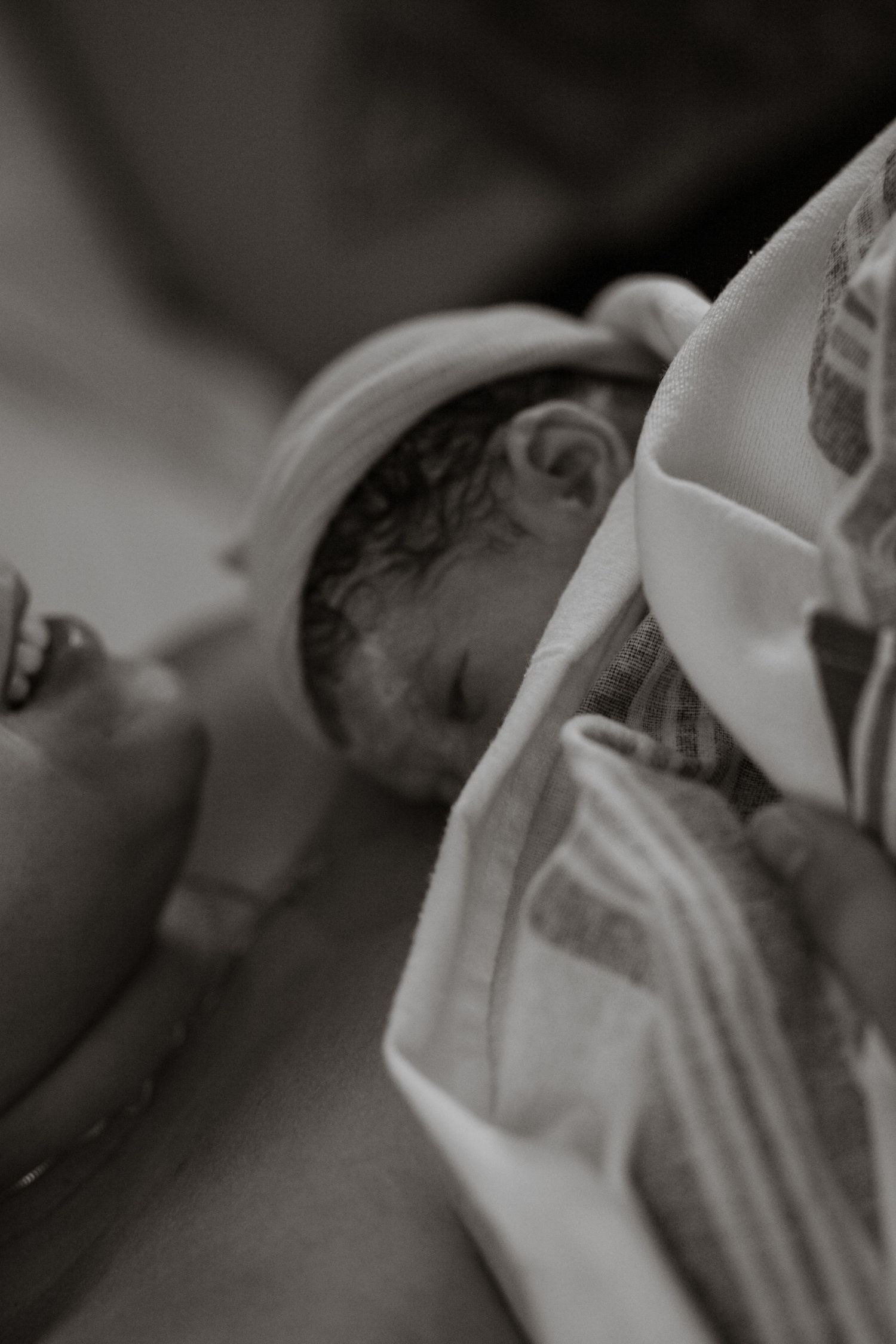 Grayscale medical sequence showing first moments after delivery in hospital setting.