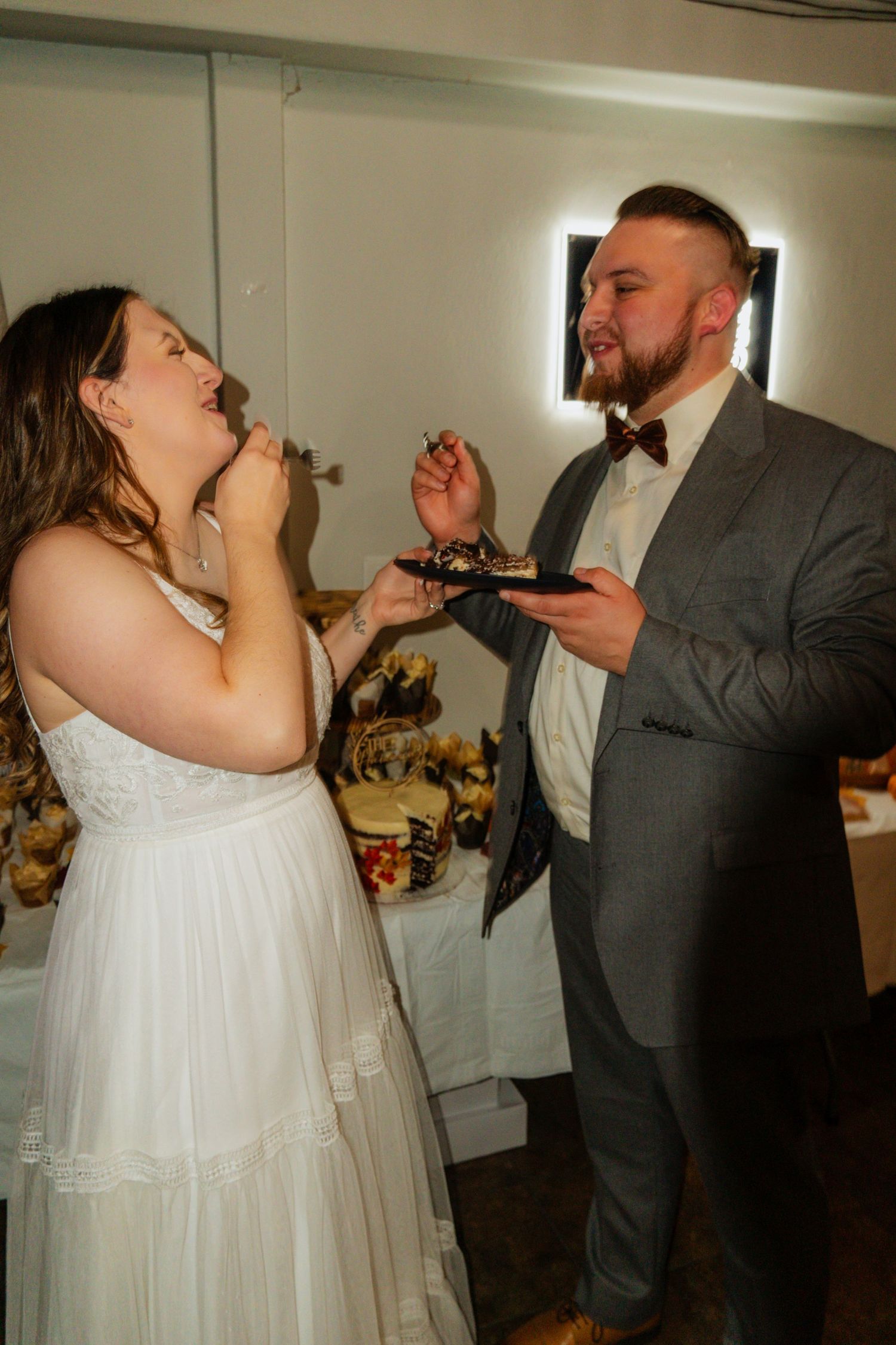 Wedding cake cutting sequence showing couple sharing their first slice together.