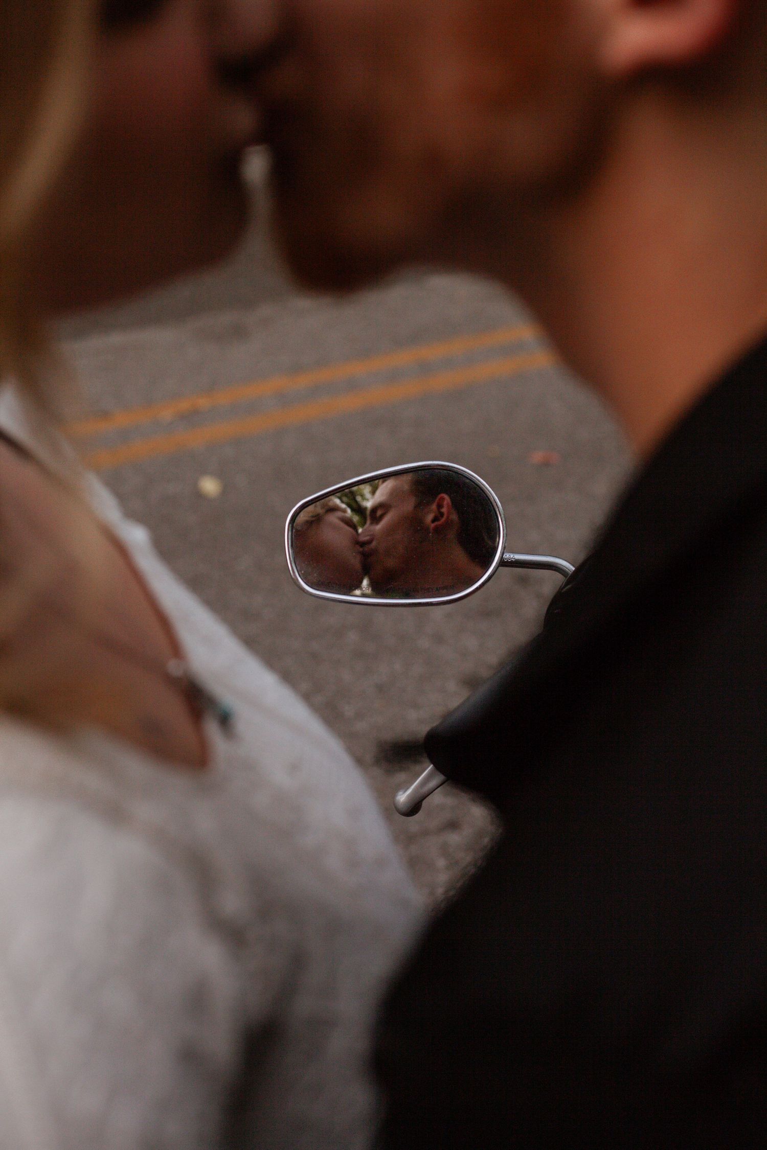 Artistic close-up shot of a couple sharing an intimate moment in dark, moody lighting.